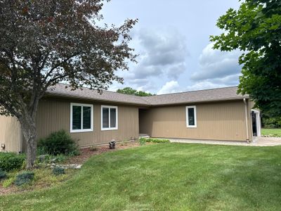 Off-White Aluminum Gutter and Downspout Replacement in Charlevoix