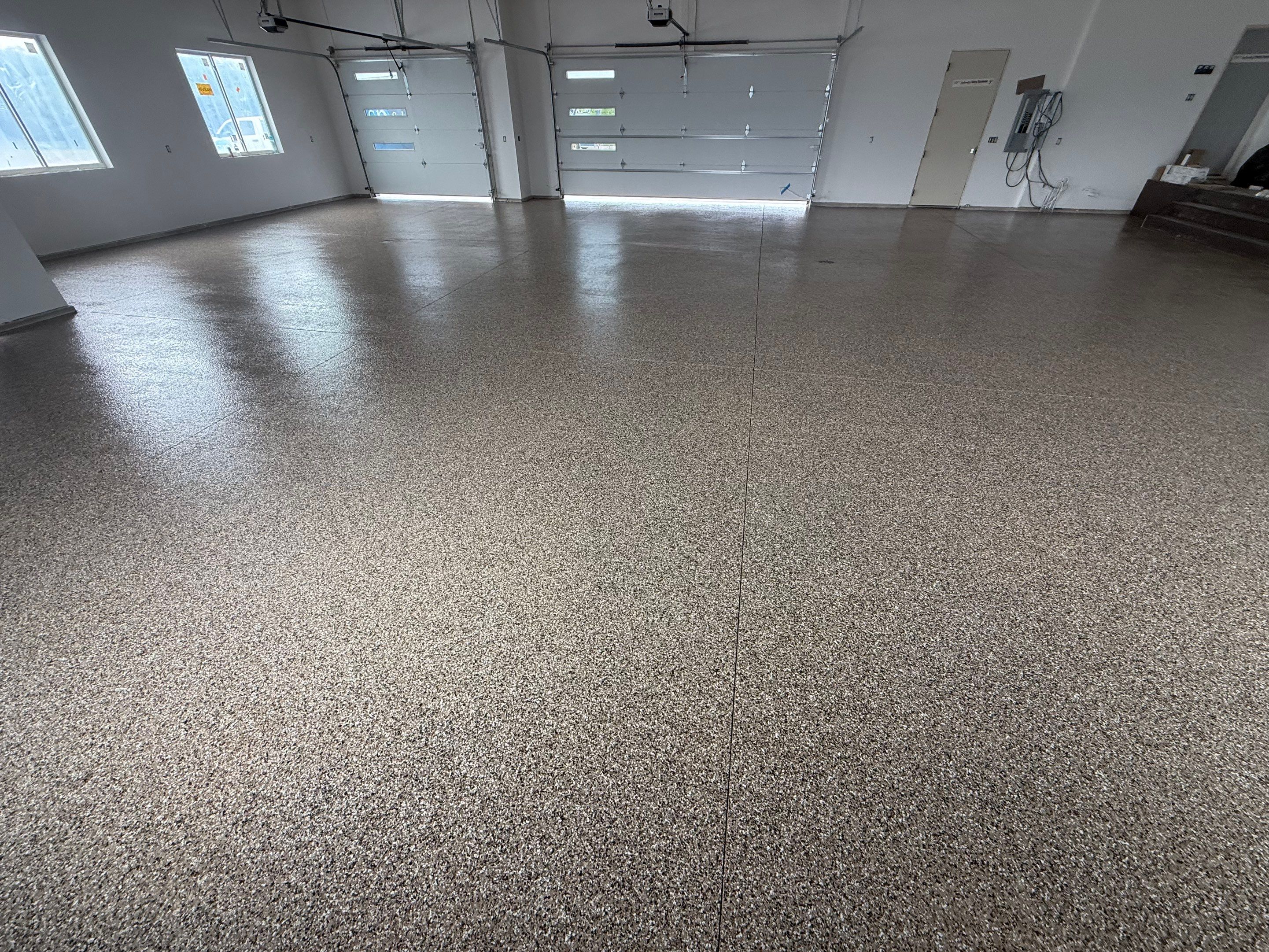 Multi-Bay Garage Concrete Coating and Floor Refinishing in South Dakota by Select Painting, Coatings & Garage Cabinets