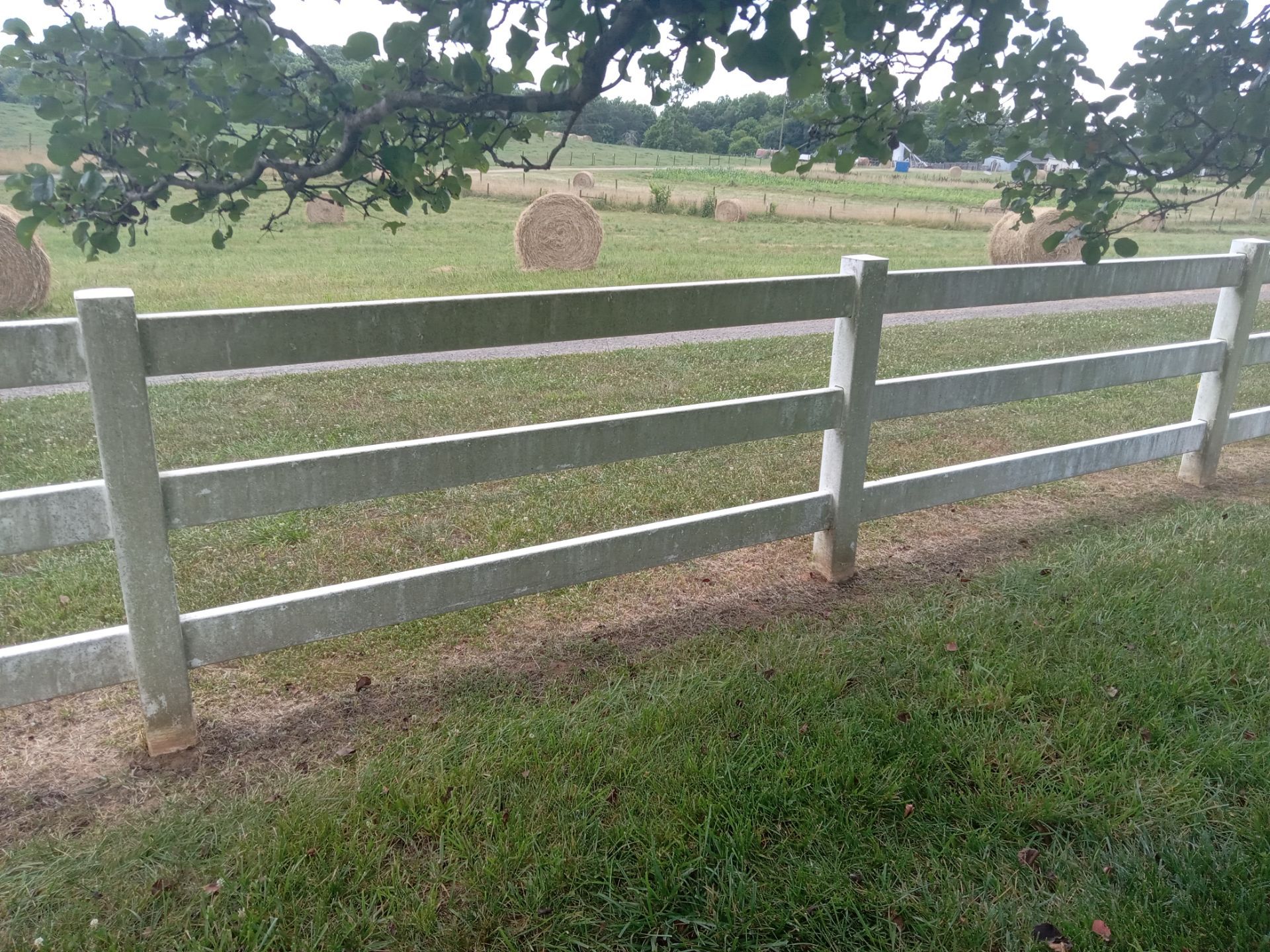 pressure washing company cleaning farm fence removing dirt and algae for restoration and maintenance of property