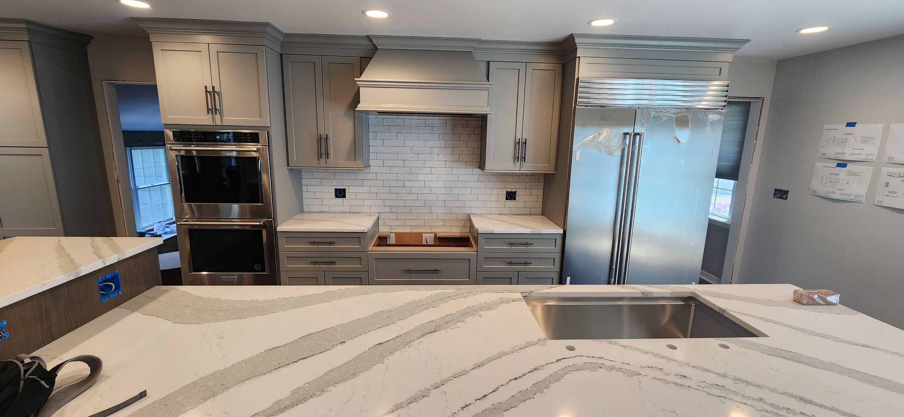 Herringbone Floor install w/ Subway Tile Backsplash by Footprints Floors Morristown
