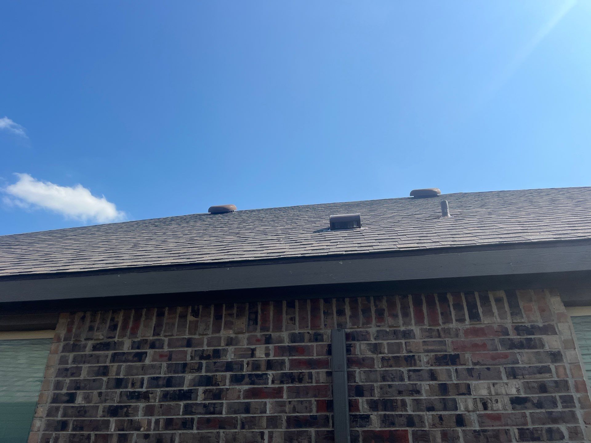Medium brown brick with IKO Driftshake by Tejas Roofworks + Restoration