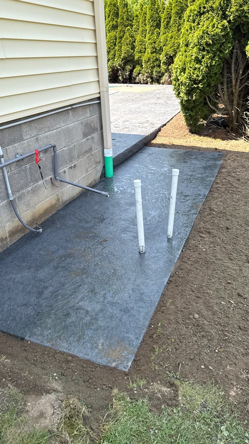 Bluestone stamped concrete patio  by NG Masonry & Construction LLC