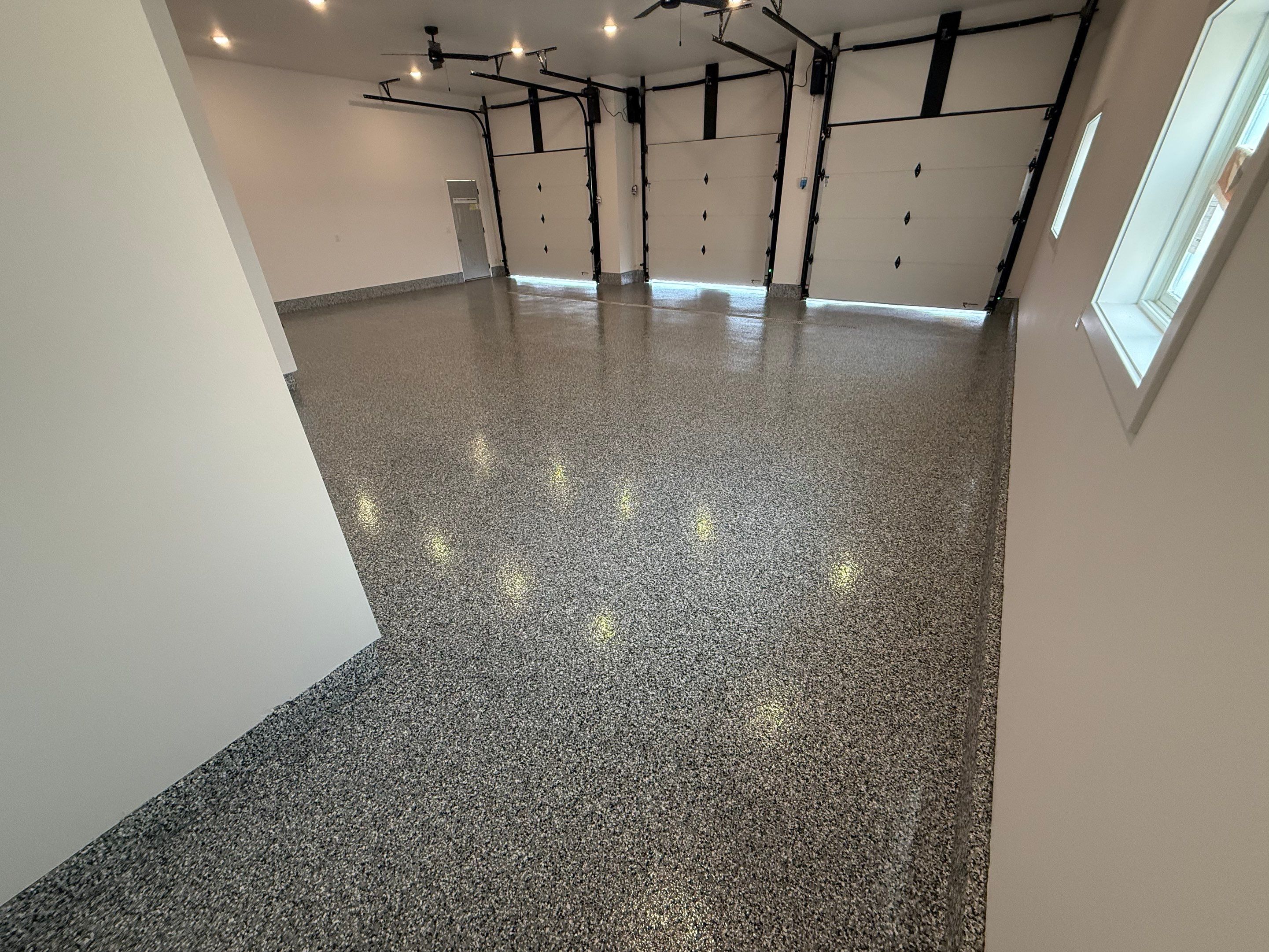 Multi-Car Garage Epoxy Floor Coating and Concrete Finishing in Sioux Falls by Select Painting, Coatings & Garage Cabinets
