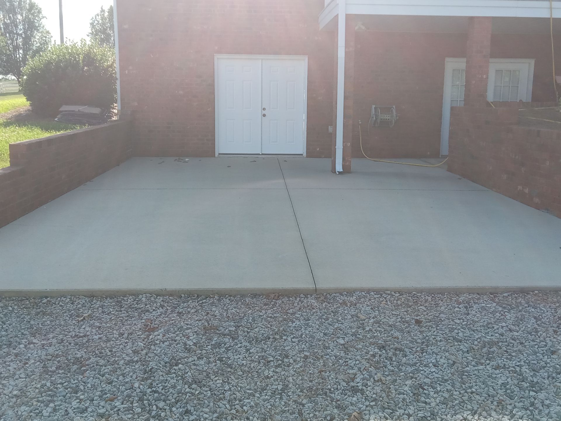 pressure washing concrete driveway and walkway removing dirt stains and debris for a clean finish