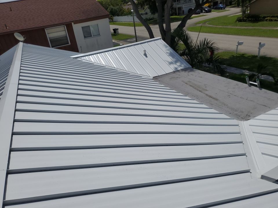 Residential Roofing Installation using 1.5" Nail Strip 24ga Solar White Kynar Coated Standing Seam Metal Panels by Morton Roofing, Inc.