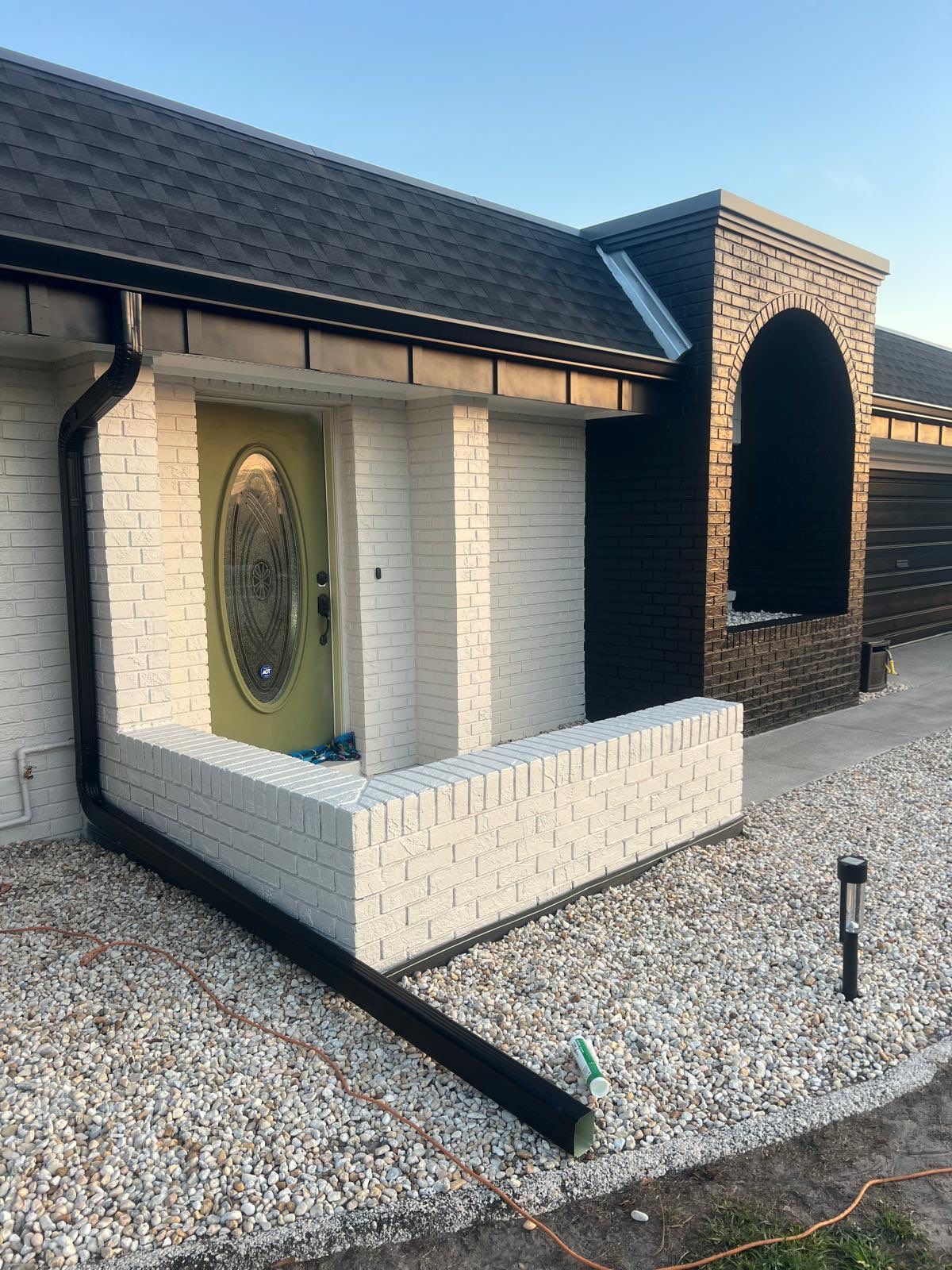 Black 6'' Seamless Gutters K-Style and Black Downspouts in Sun City Center FL by Gutter Professors