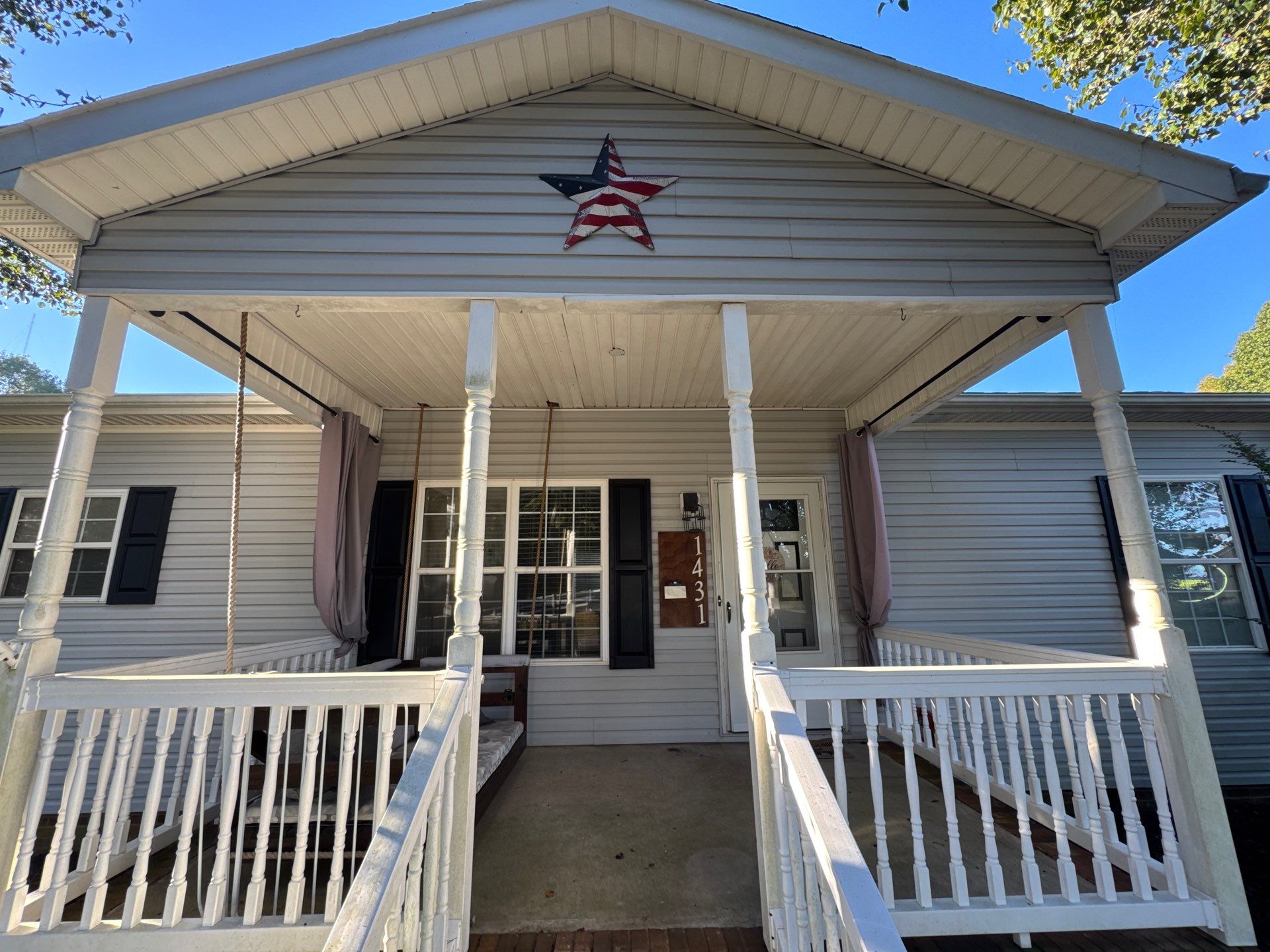 the service shown is cleaning the house siding and porch area to remove dirt and grime for a refreshed appearance