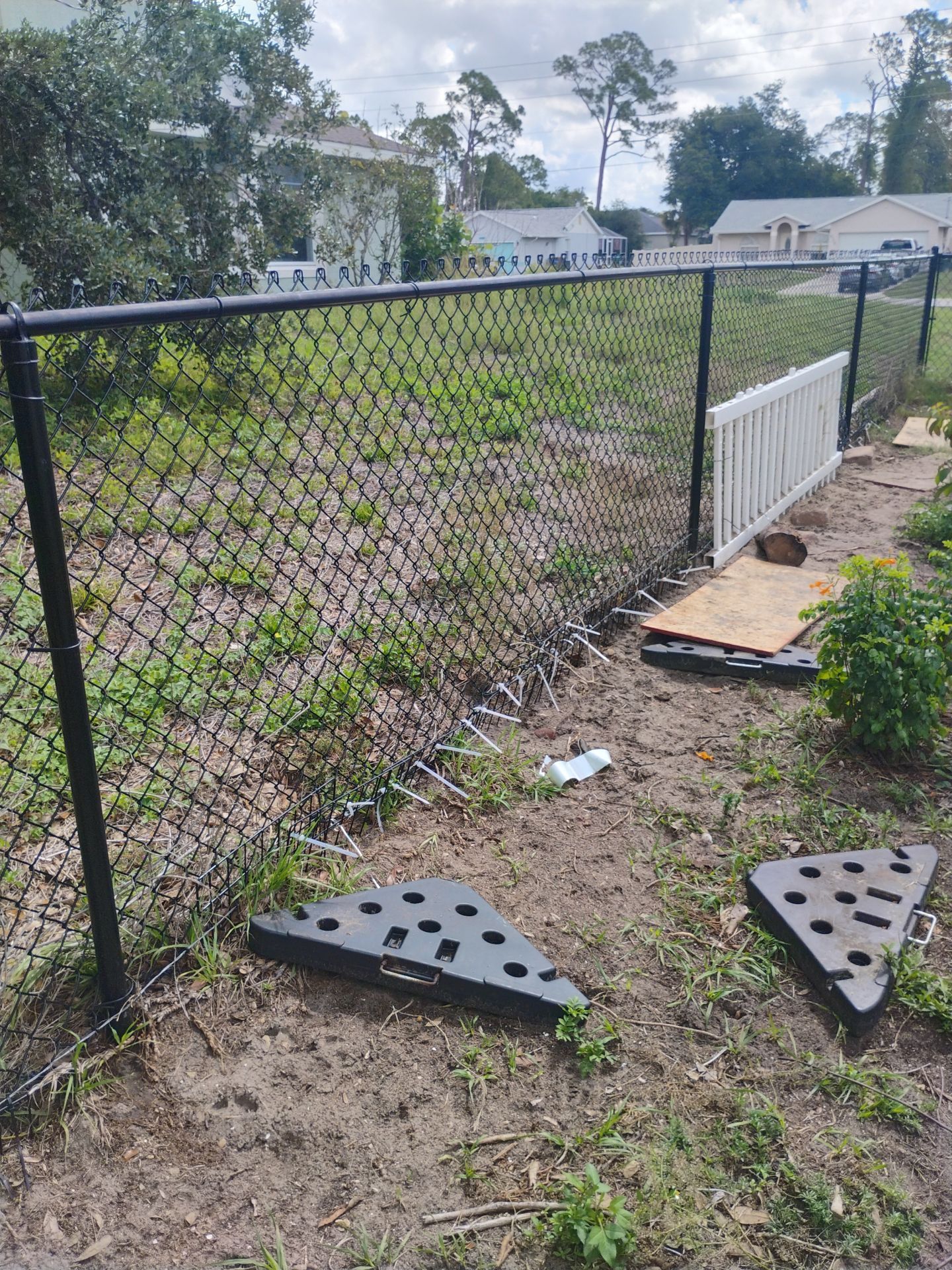 White and Gray Vinyl Privacy Fence Installation in North Port by True Fence LLC