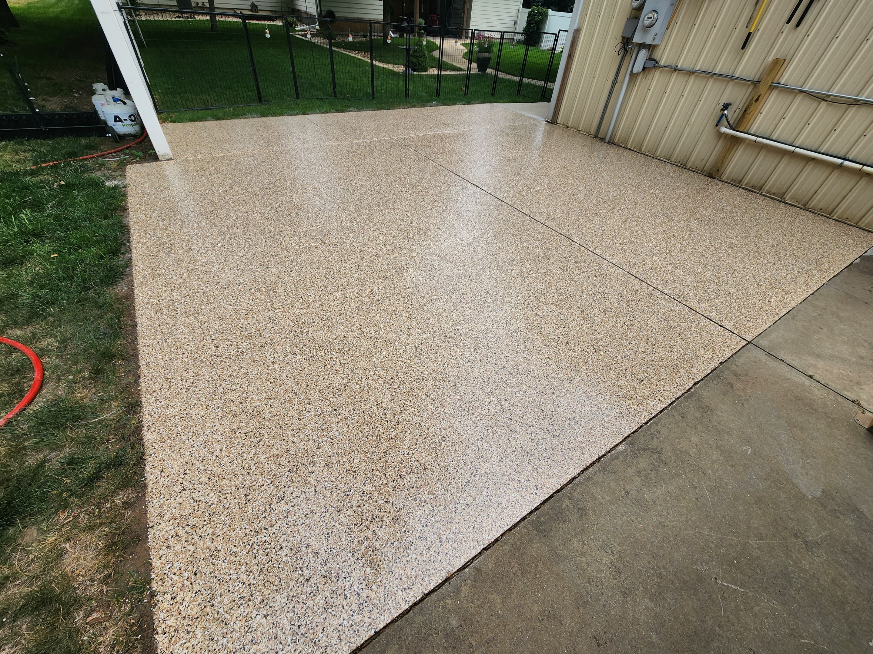 Speckled Epoxy Concrete Patio Coating Installation in Hurley by Select Painting, Coatings & Garage Cabinets