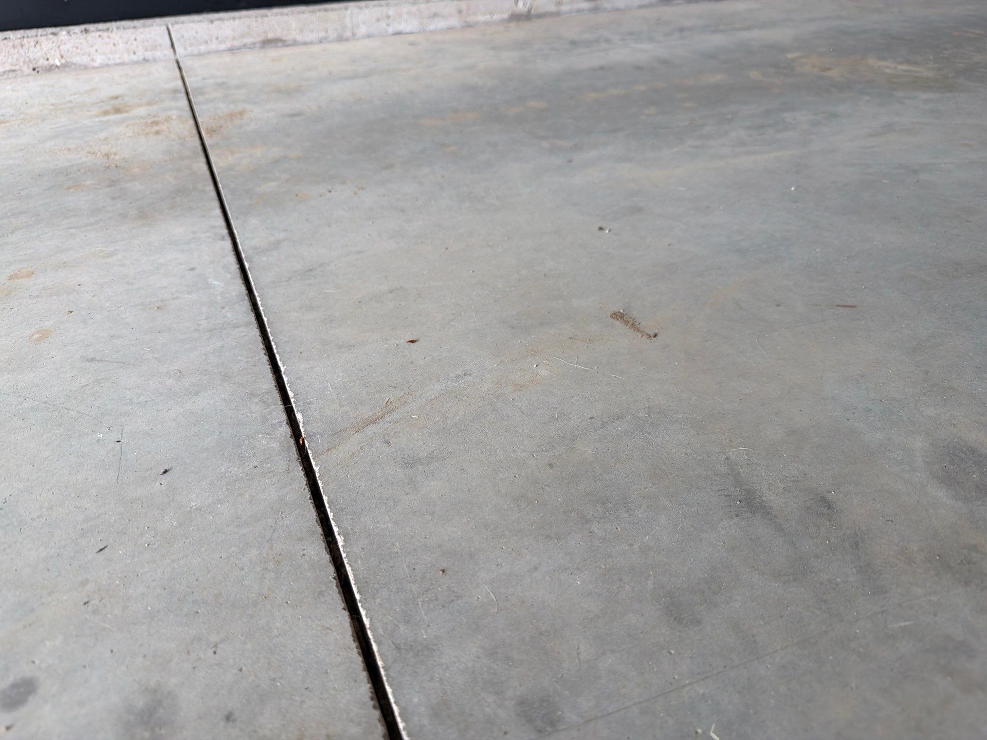 Custom Epoxy Garage Floor Coating Installation in Sioux Falls by Select Painting, Coatings & Garage Cabinets