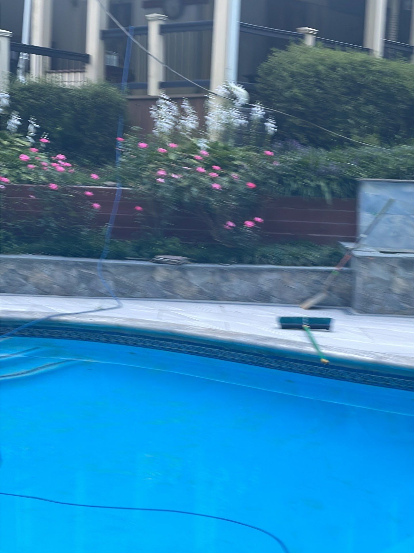 Pool Surround remodel with retaining walls, new waterfall and water slide by Fairfax Contractors, LLC