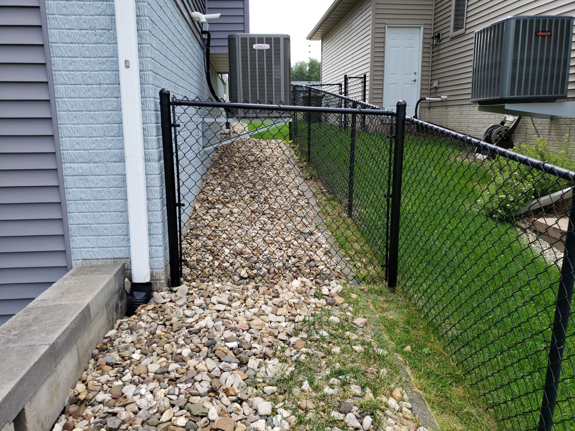 Black Vinyl Chain Link Perimeter Fence Installation in Waterloo by Perfect Picket Fence and Stain