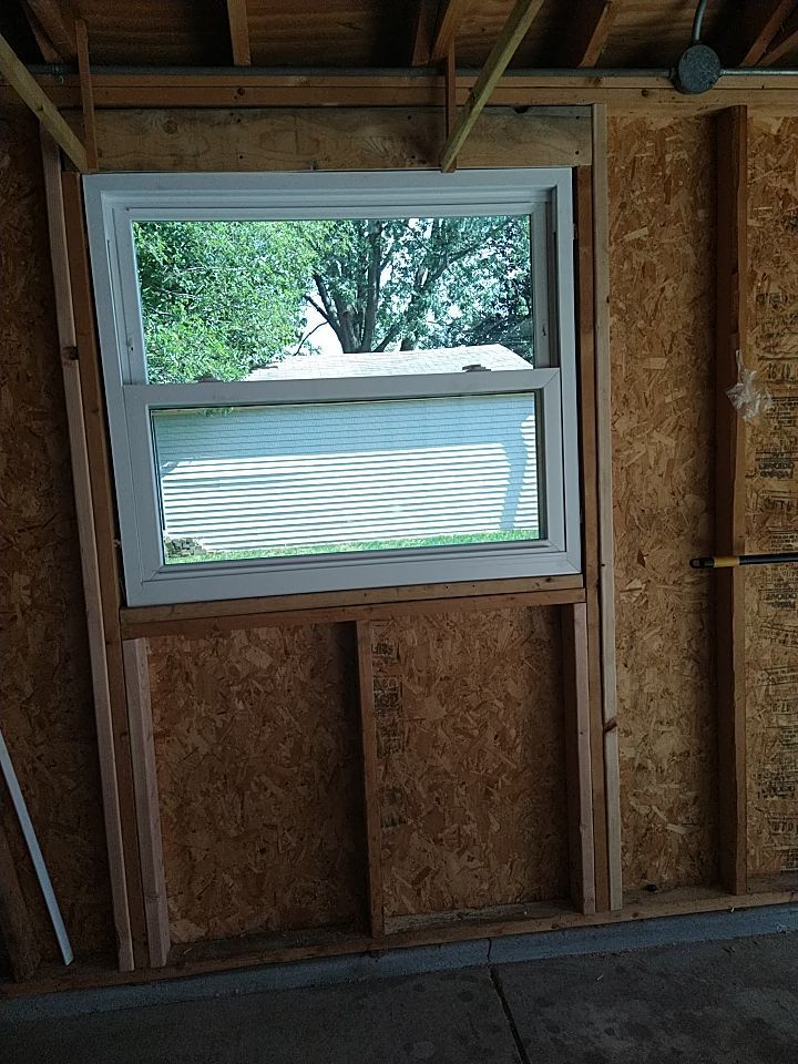 Siding Installation using Norandex woodsman dl-5 white woodgrain vinyl by Absolute Roofing and Construction