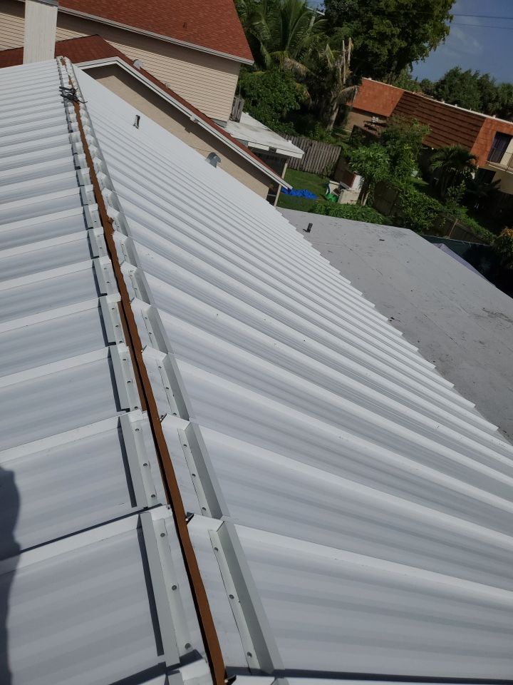 Residential Roofing Installation using 1.5" Nail Strip 24ga Solar White Kynar Coated Standing Seam Metal Panels by Morton Roofing, Inc.
