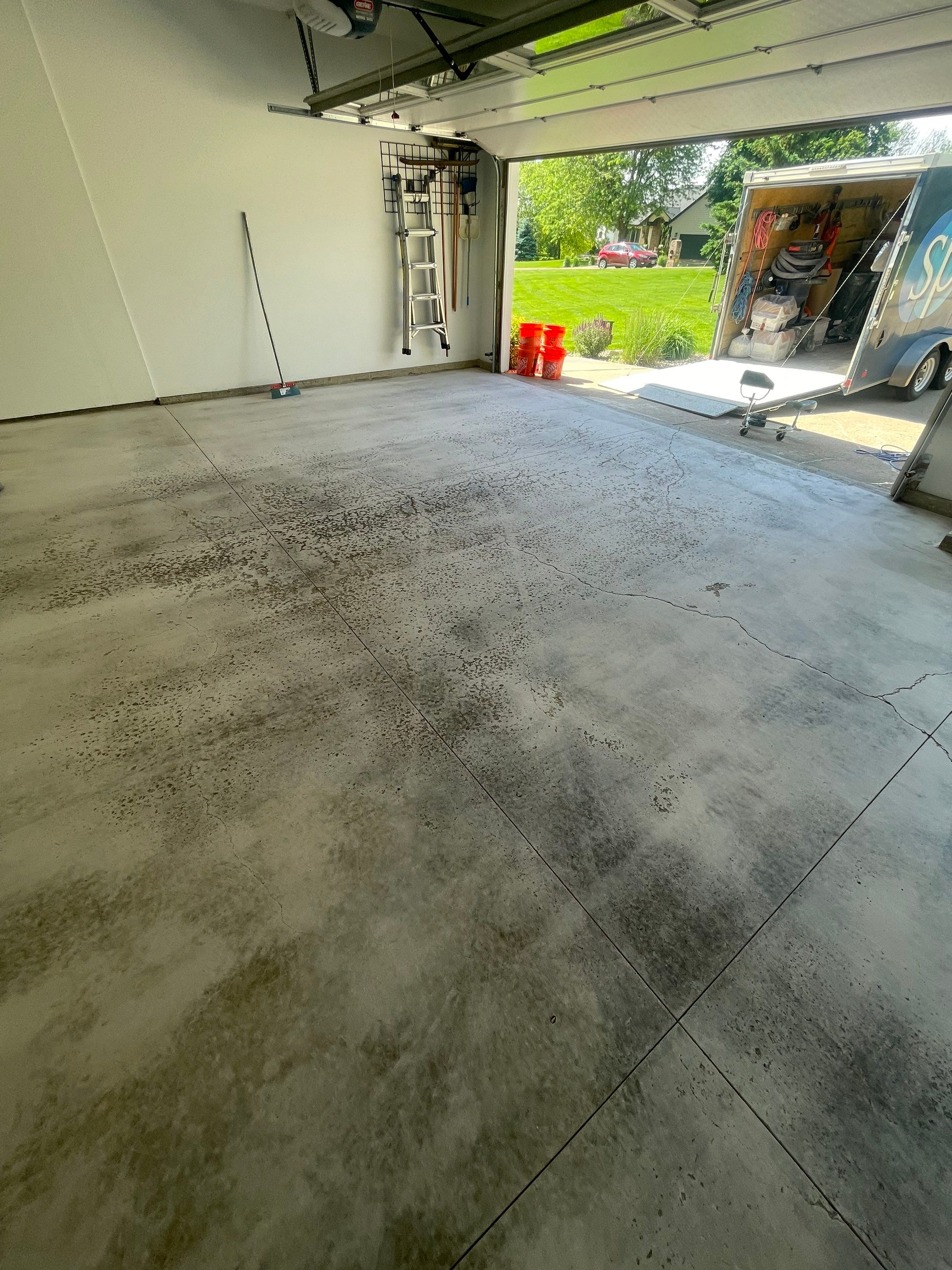 Feather Grey Garage Floor Coating Installation in Sioux Falls by Select Painting, Coatings & Garage Cabinets