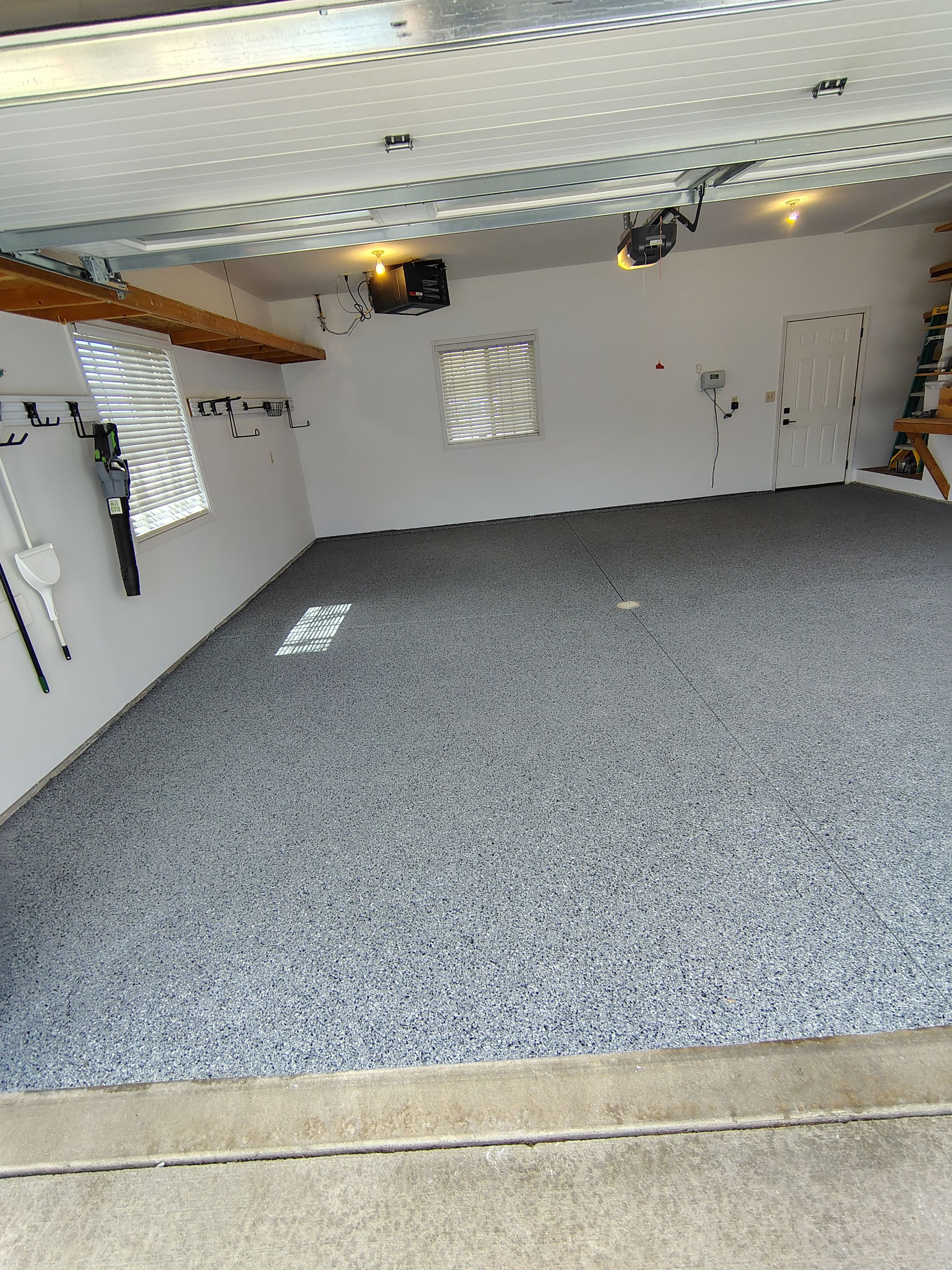 Grey Speckled Epoxy Garage Floor Coating in Sioux Falls by Select Painting, Coatings & Garage Cabinets