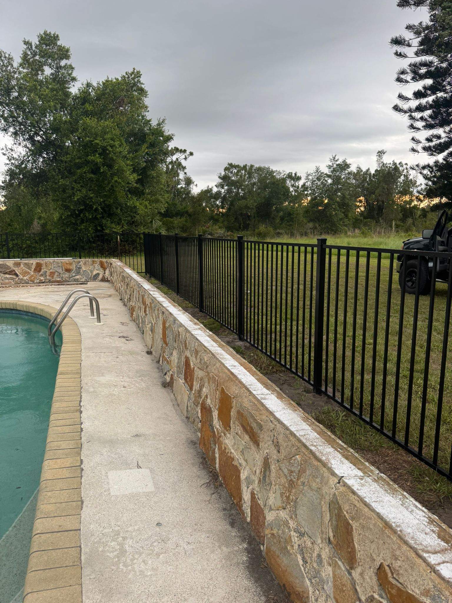 Black Aluminum Pool Safety Fence Installation in Punta Gorda by True Fence LLC