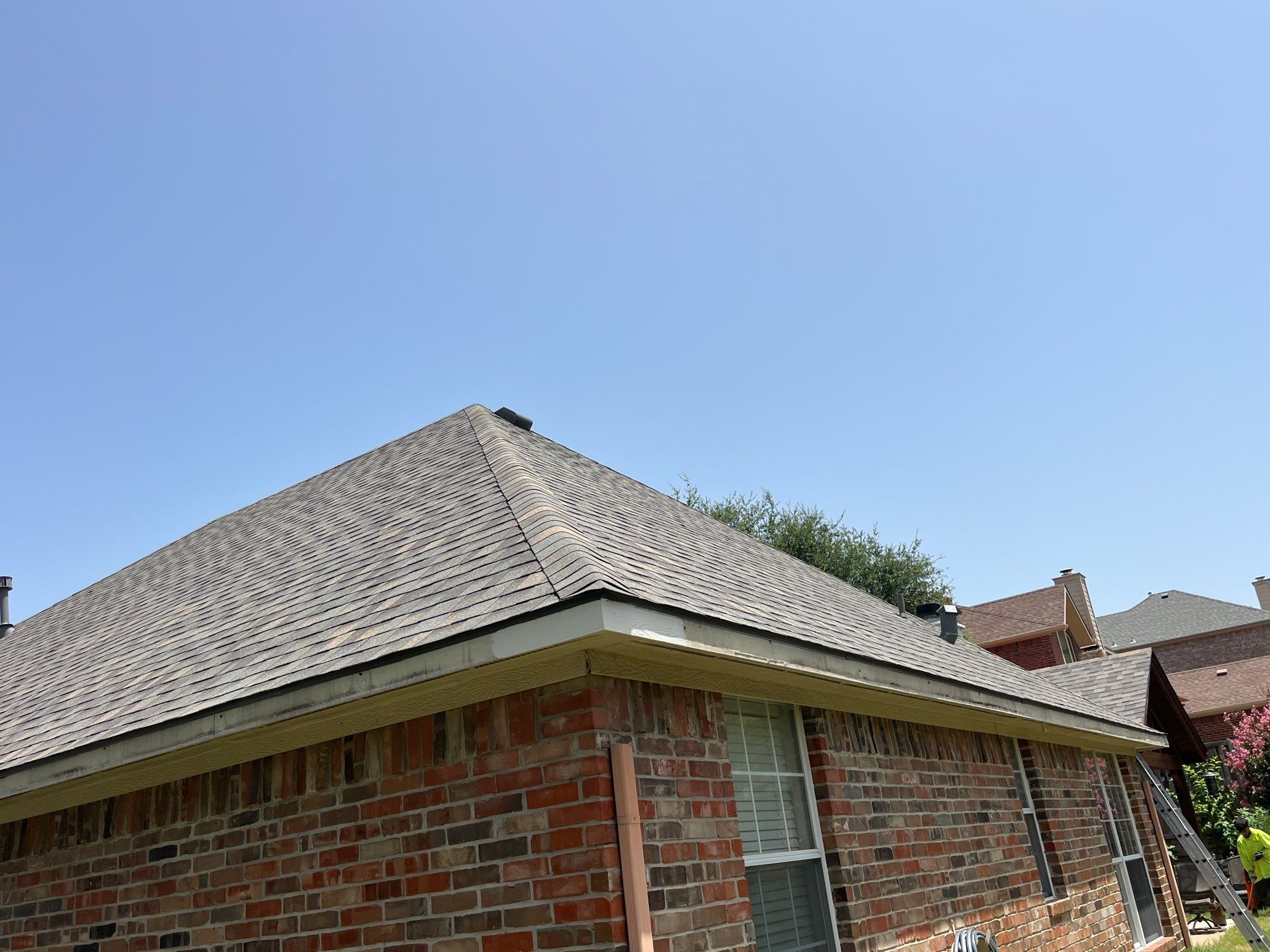 Red brick with IKO Cornerstone  by Tejas Roofworks + Restoration