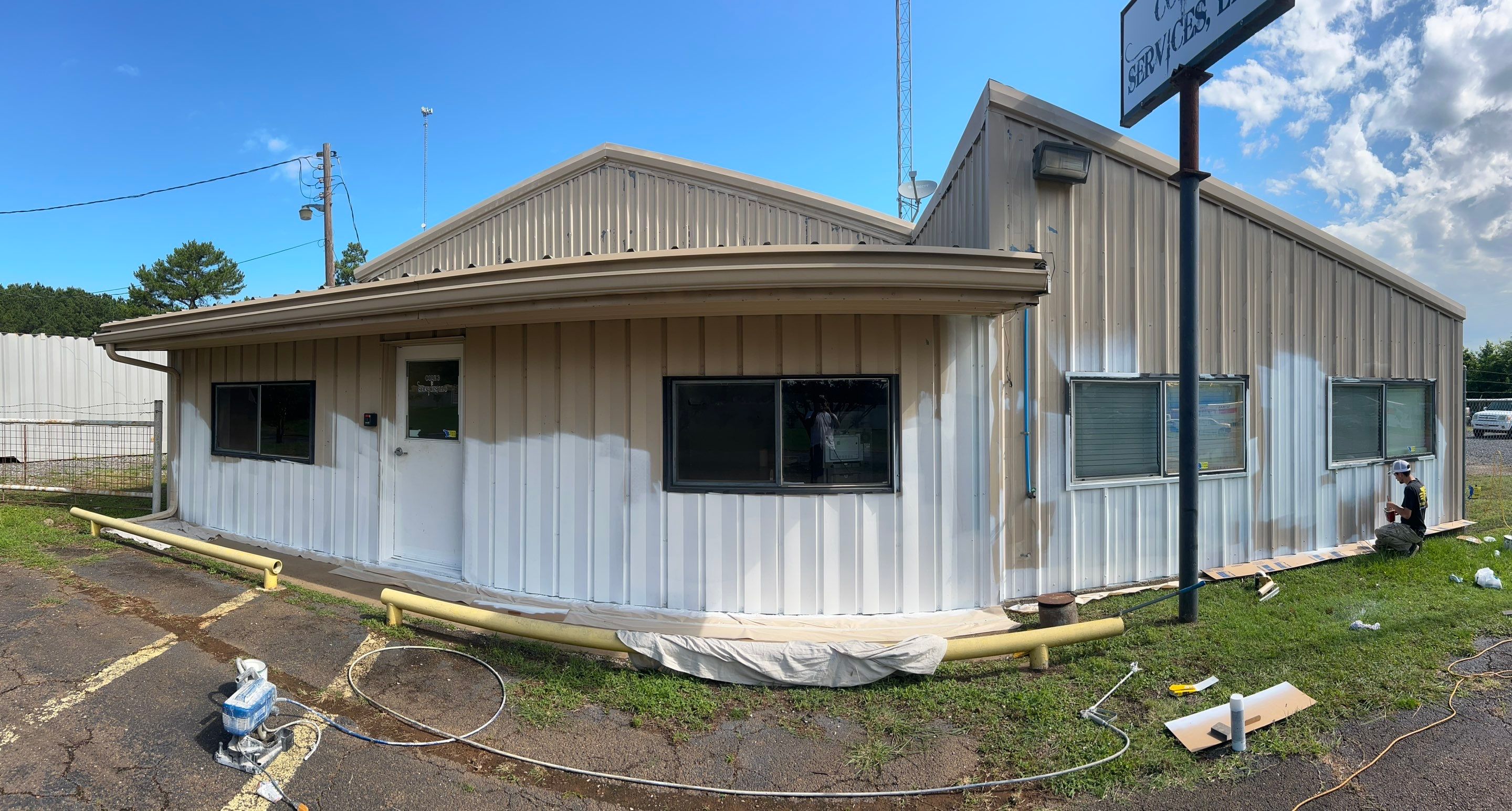 Exterior Painting in Kilgore, TX | Metal Building Transformation from White to Grey by Quality Coats Painting