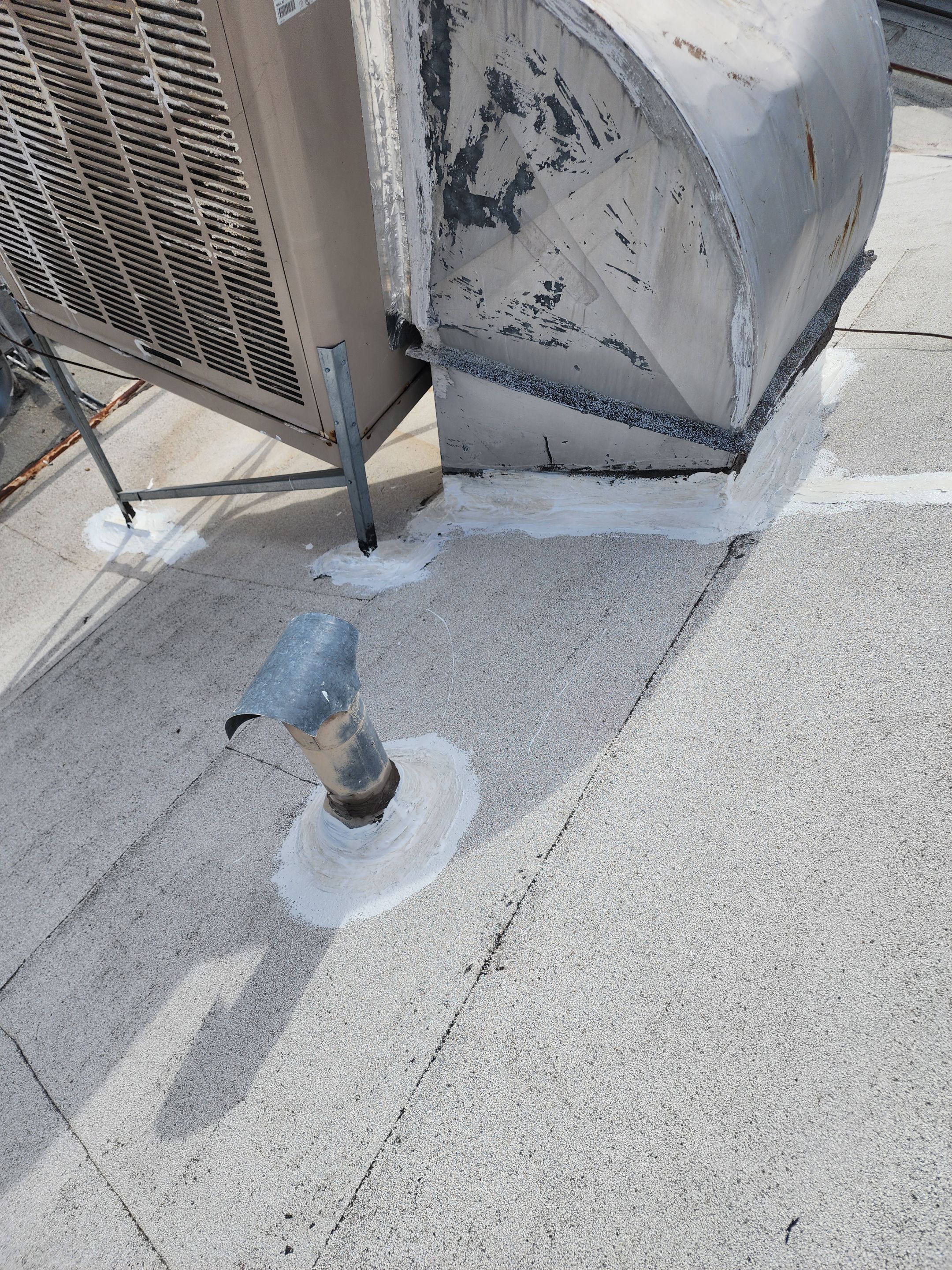 Foam and coatings on commercial roof by Straight Edge Roofing Inc