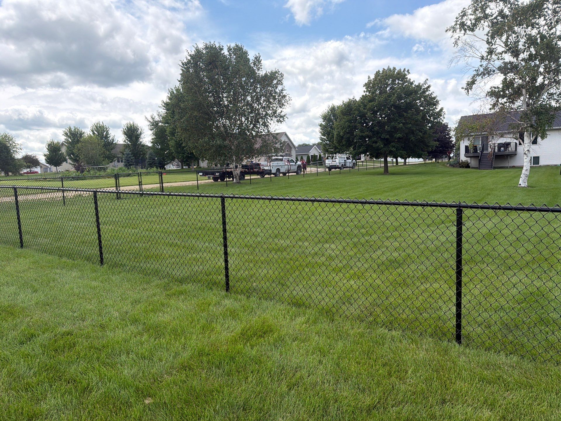 Black Vinyl-Coated Chain Link Fence Installation in Fairbank by Perfect Picket Fence and Stain