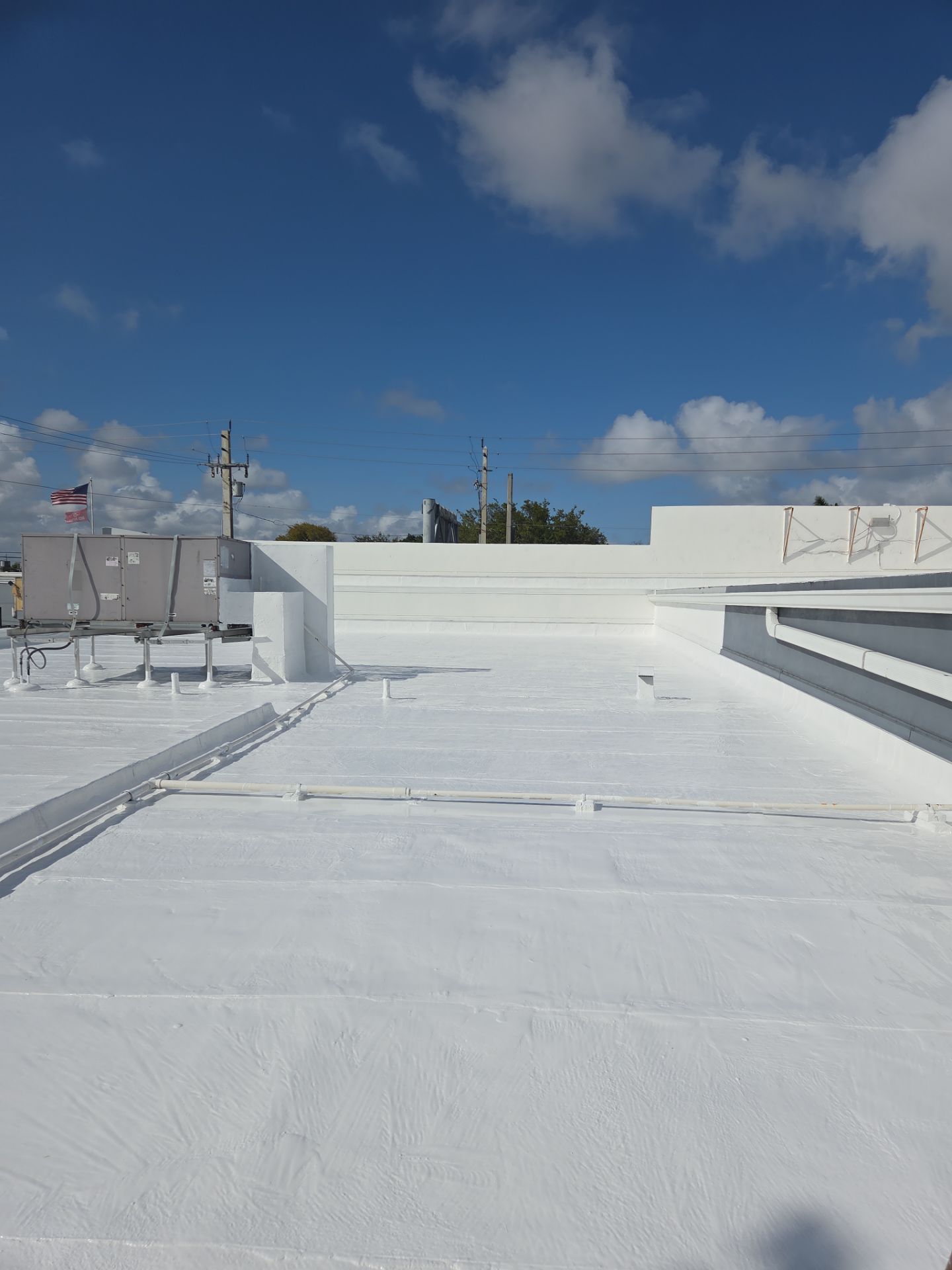 Commercial Flat Roof Restoration Using Silicone Coating in Hallandale Beach by Aastro Roofing