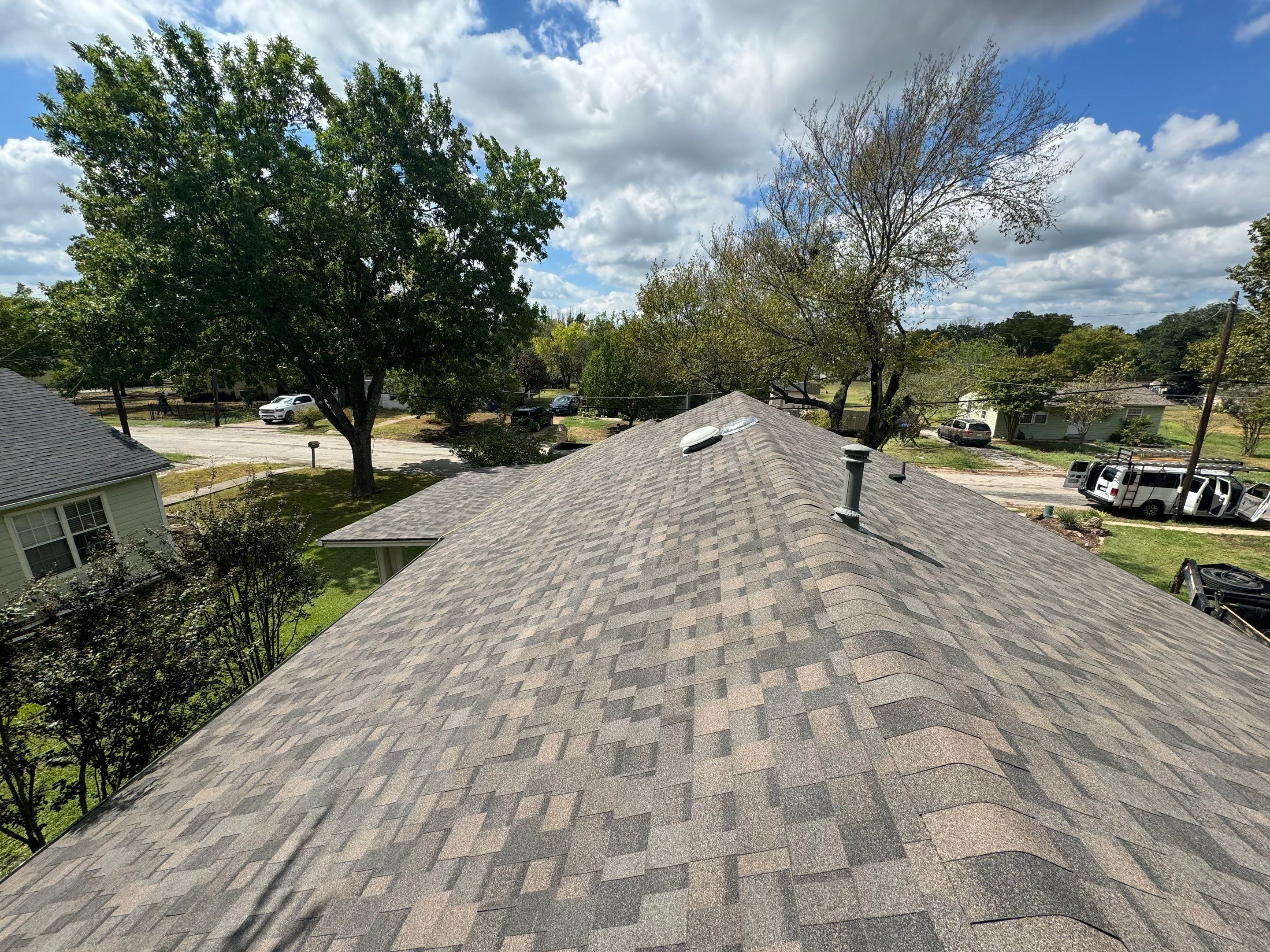 IKO Driftshake-Dark green siding house by Tejas Roofworks + Restoration