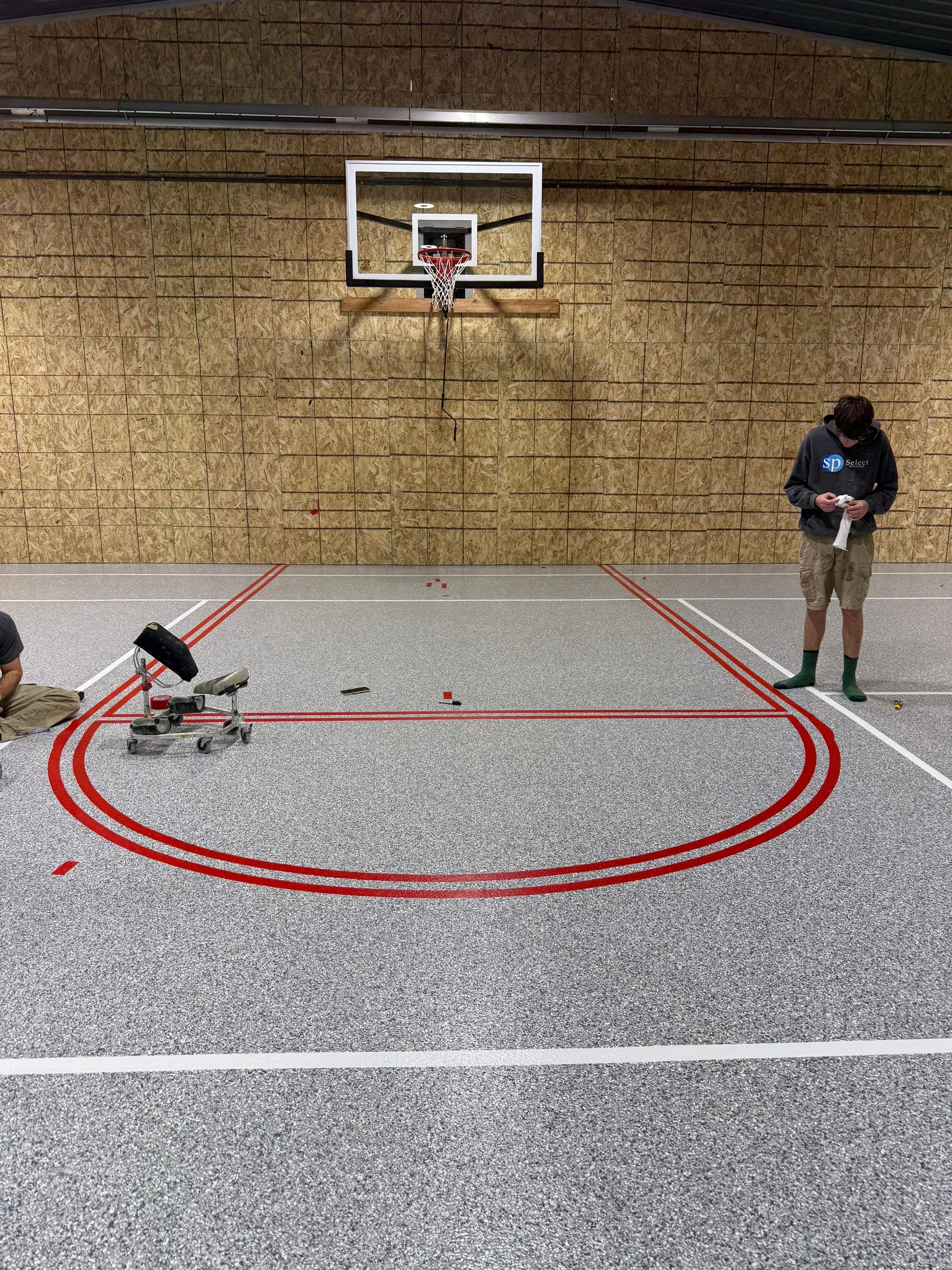 Custom Polyurea Shop Floor with Basketball Court Lines in Rock Valley by Select Painting, Coatings & Garage Cabinets