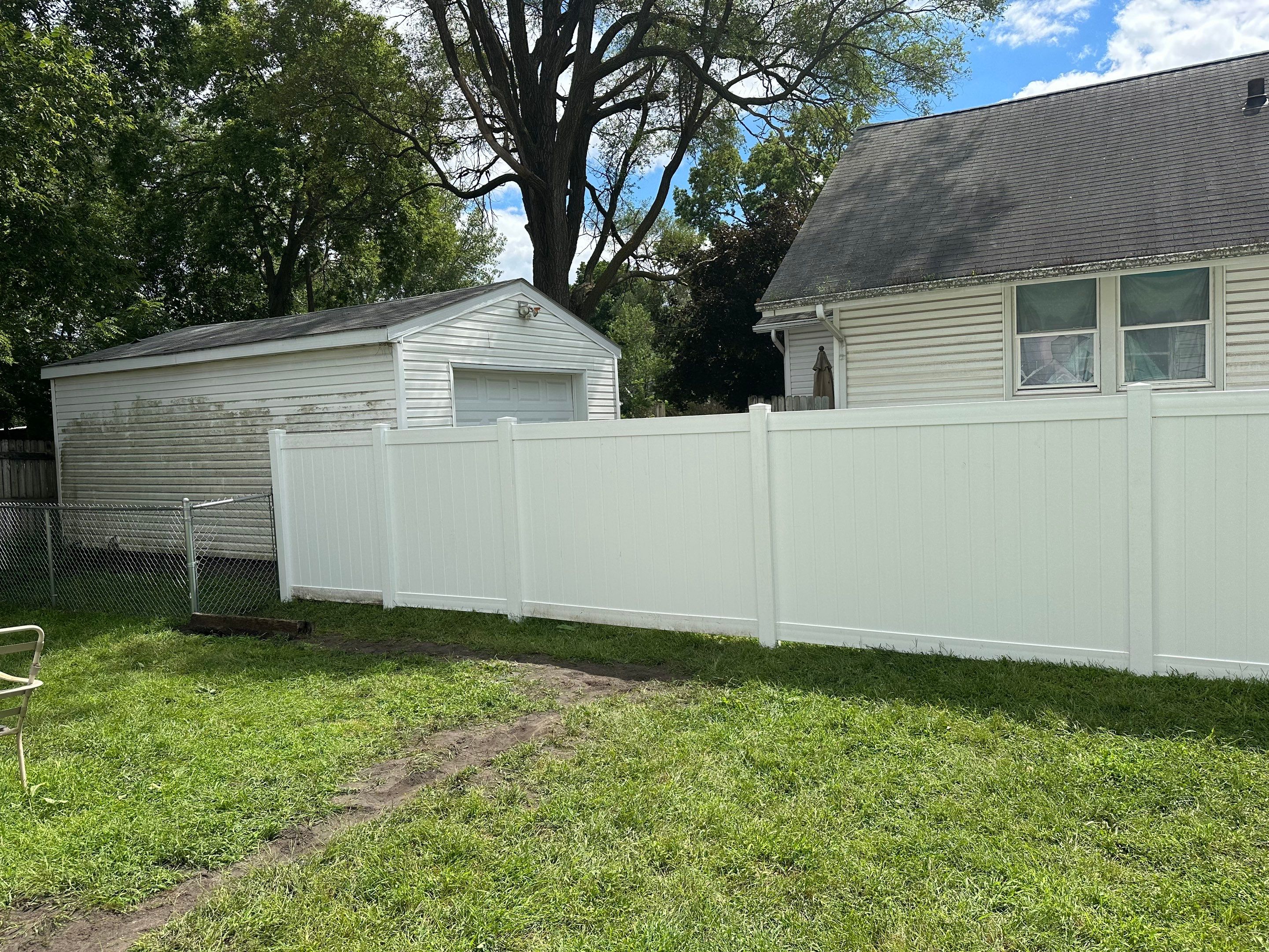 Residential White Vinyl Privacy Fence Installation in Waterloo, Iowa by Perfect Picket Fence and Stain