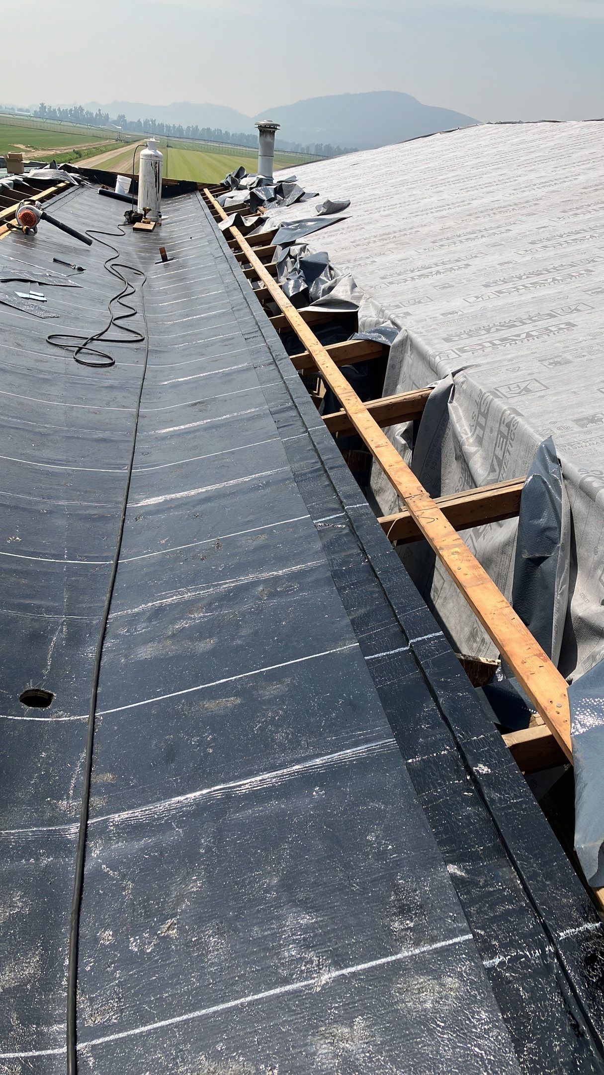 Residential Roofing Installation using IKO 2ply sbs on existing building by Top Notch Roofing Inc