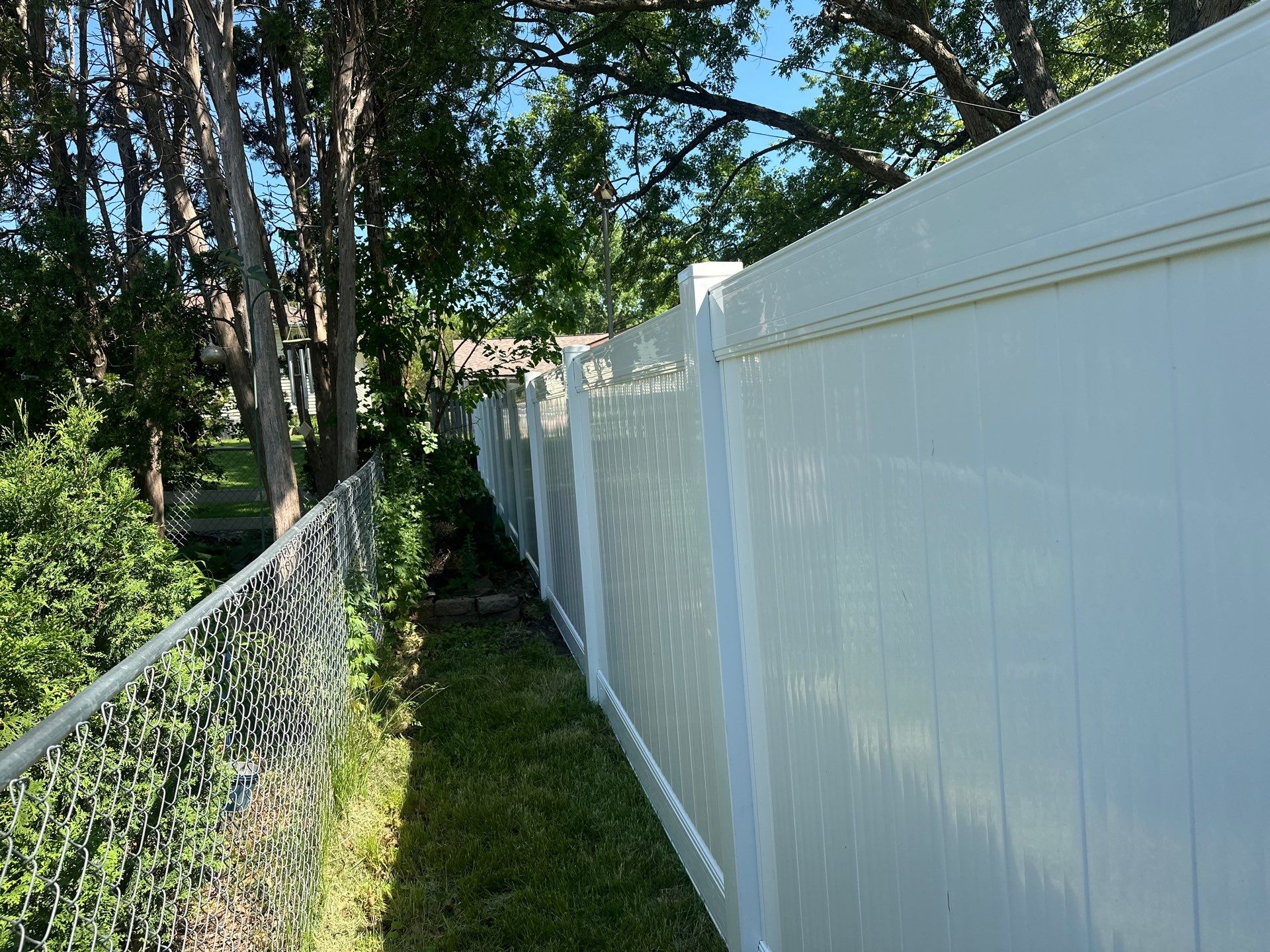 White Vinyl Privacy Fence and Double Gate Installation in Cedar Falls by Perfect Picket Fence and Stain