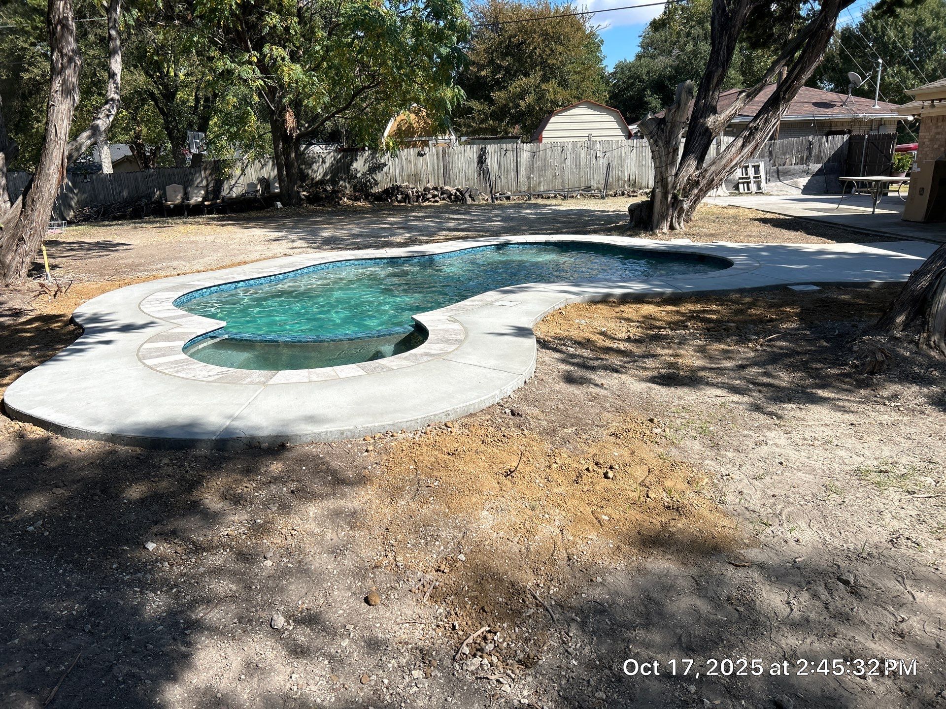 Freeform Pool Remodel with New Decking and Pebble Interior by Pinnacle Pools and Spas - DFW