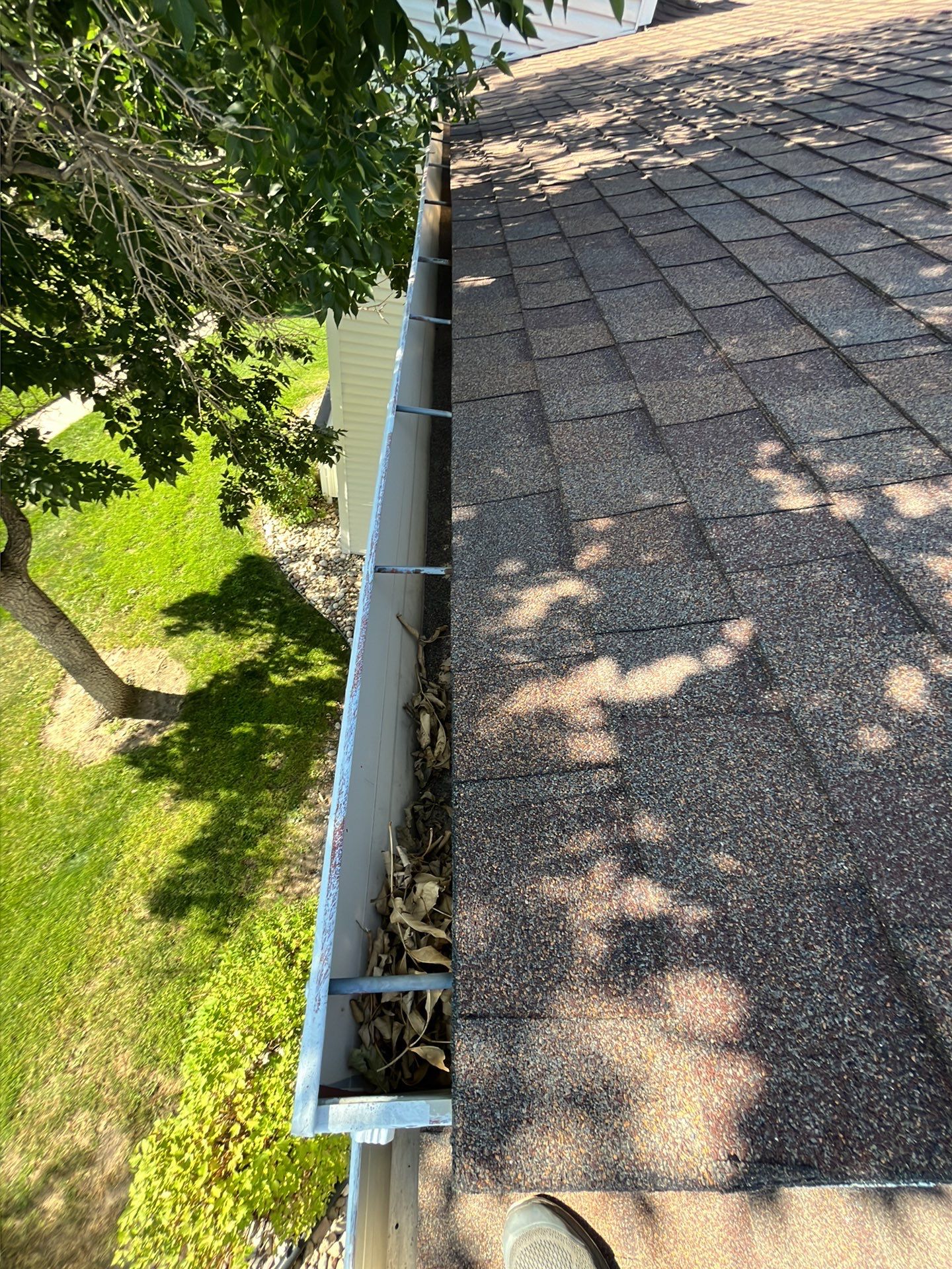 Commercial gutter cleaning Lincoln, NE before photo with filled gutters