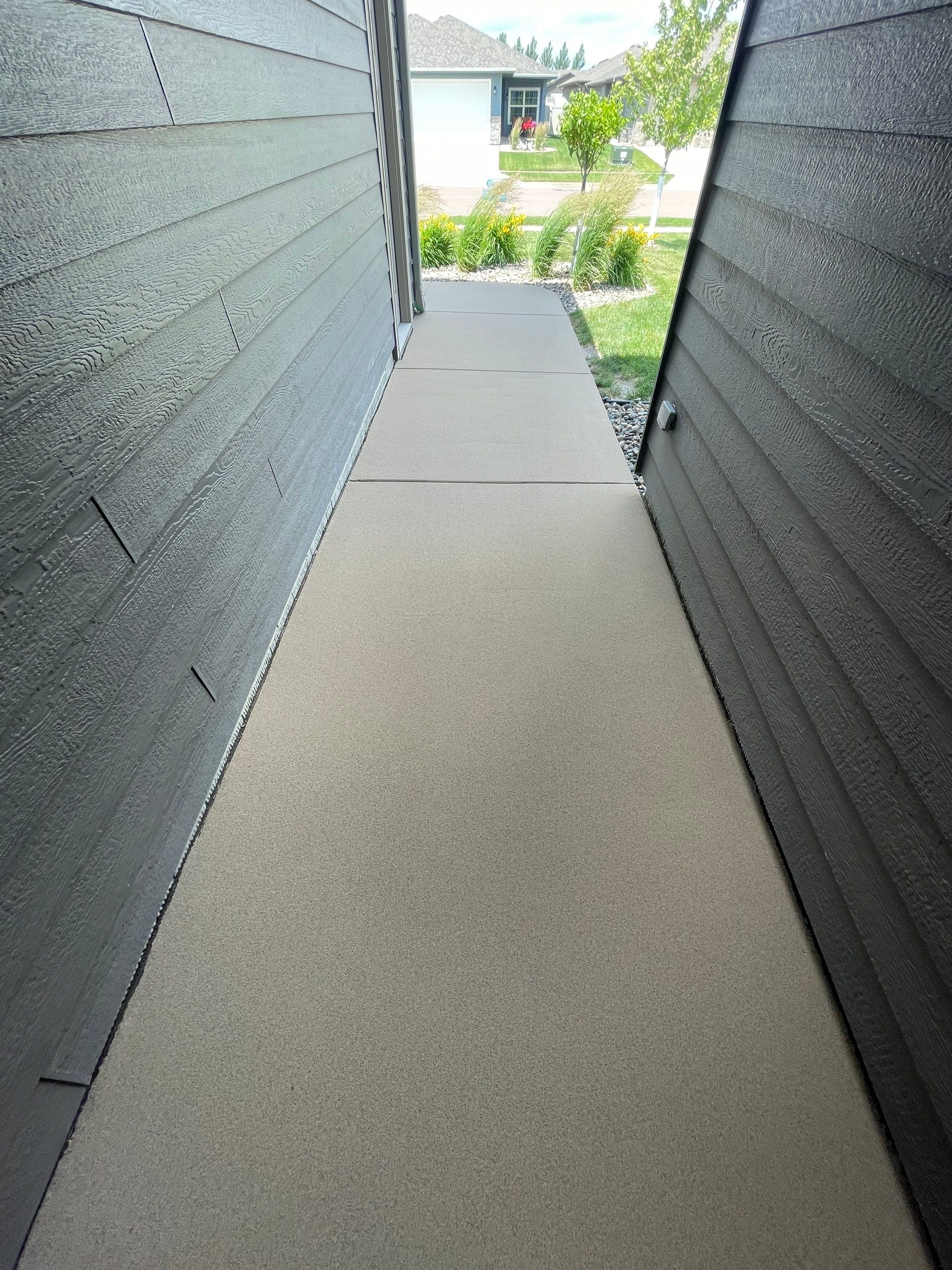 Textured Concrete Patio Coating and Custom Privacy Pergola in Sioux Falls by Select Painting, Coatings & Garage Cabinets