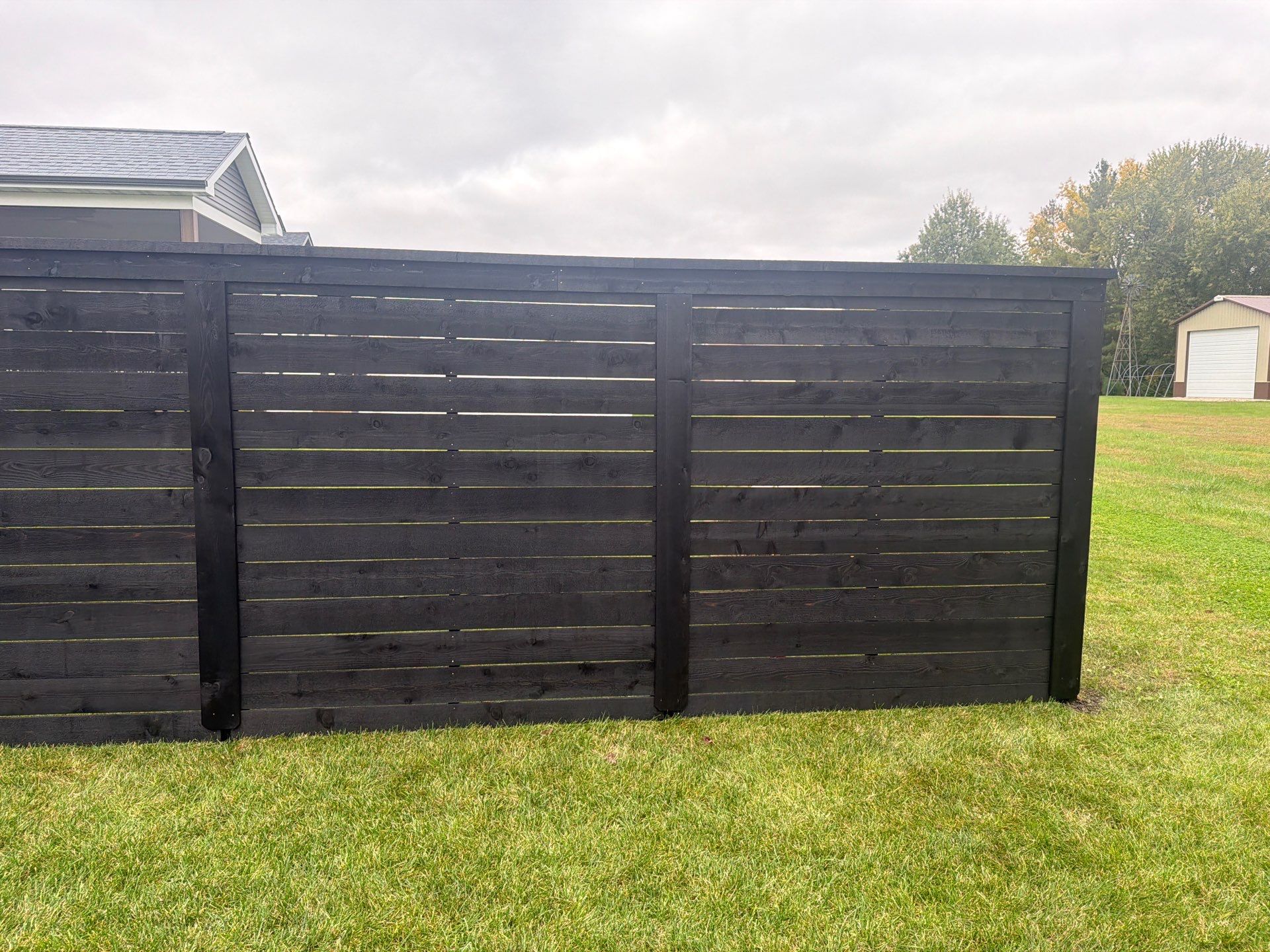 Modern Horizontal Wood Privacy Fence Installation in Cedar Falls by Perfect Picket Fence and Stain