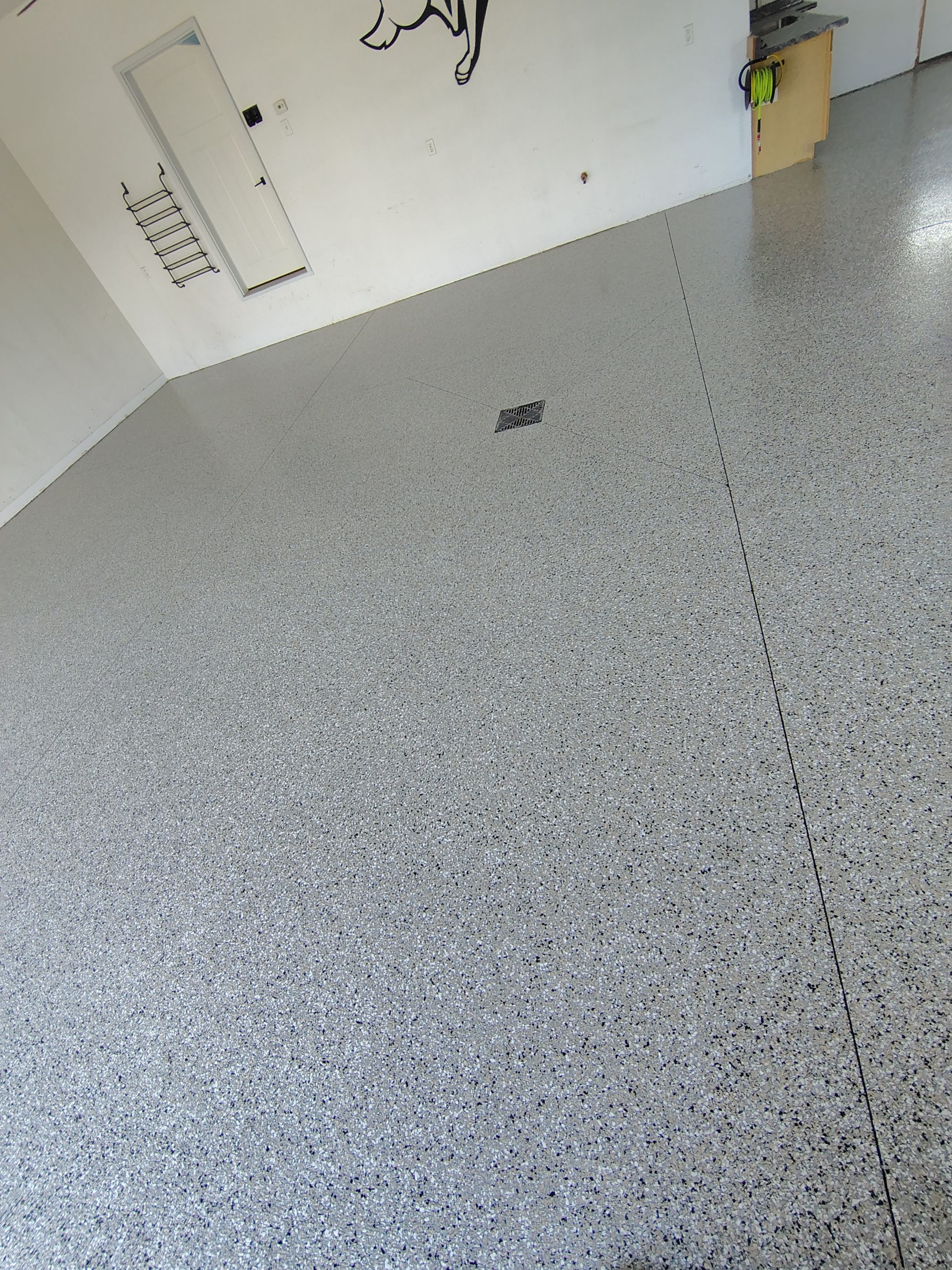 Speckled Polyaspartic Garage Floor Coating Installation in Dell Rapids by Select Painting, Coatings & Garage Cabinets