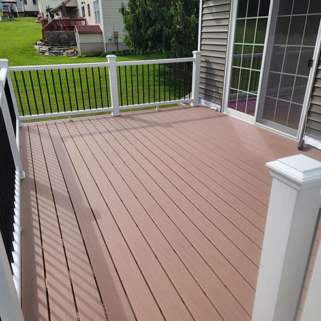 New Two Tier deck using Trex Hatteras boards and White Composite railings. by DiGiorgi Roofing and Siding Inc