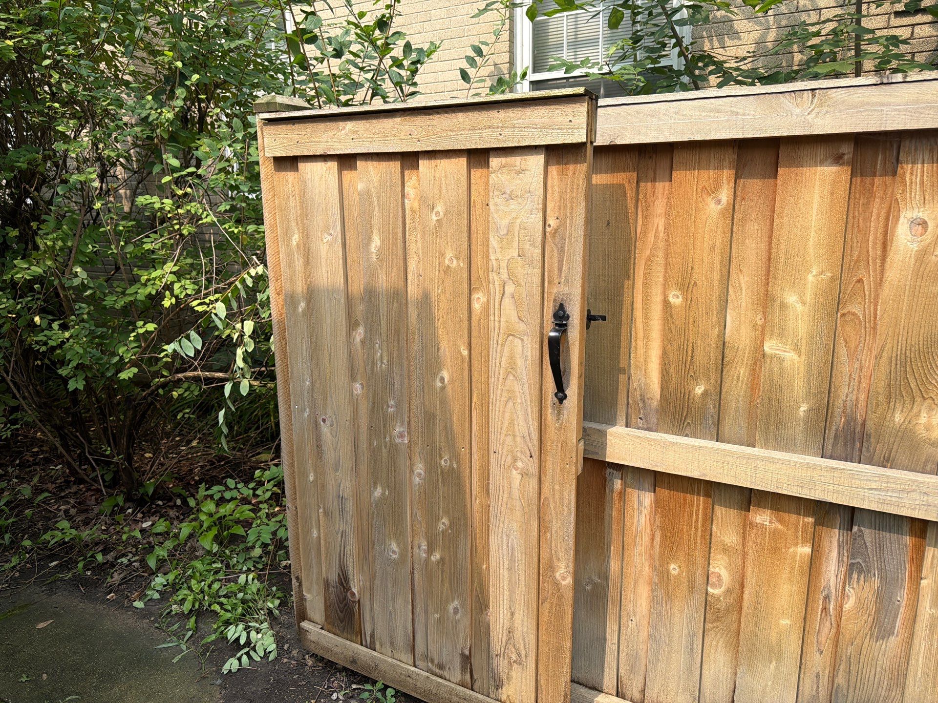 Wood fence cleaning and sealing by Northern Power Washing LLC.