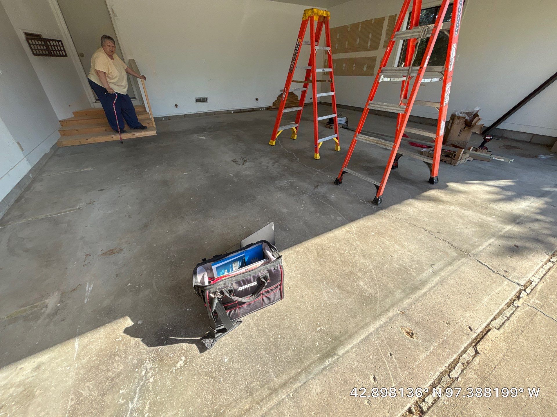 Grey Speckled Concrete Coating for Residential Garage in Yankton by Select Painting, Coatings & Garage Cabinets