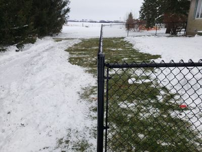 Black Vinyl-Coated Chain Link Fence Installation in Oelwein
