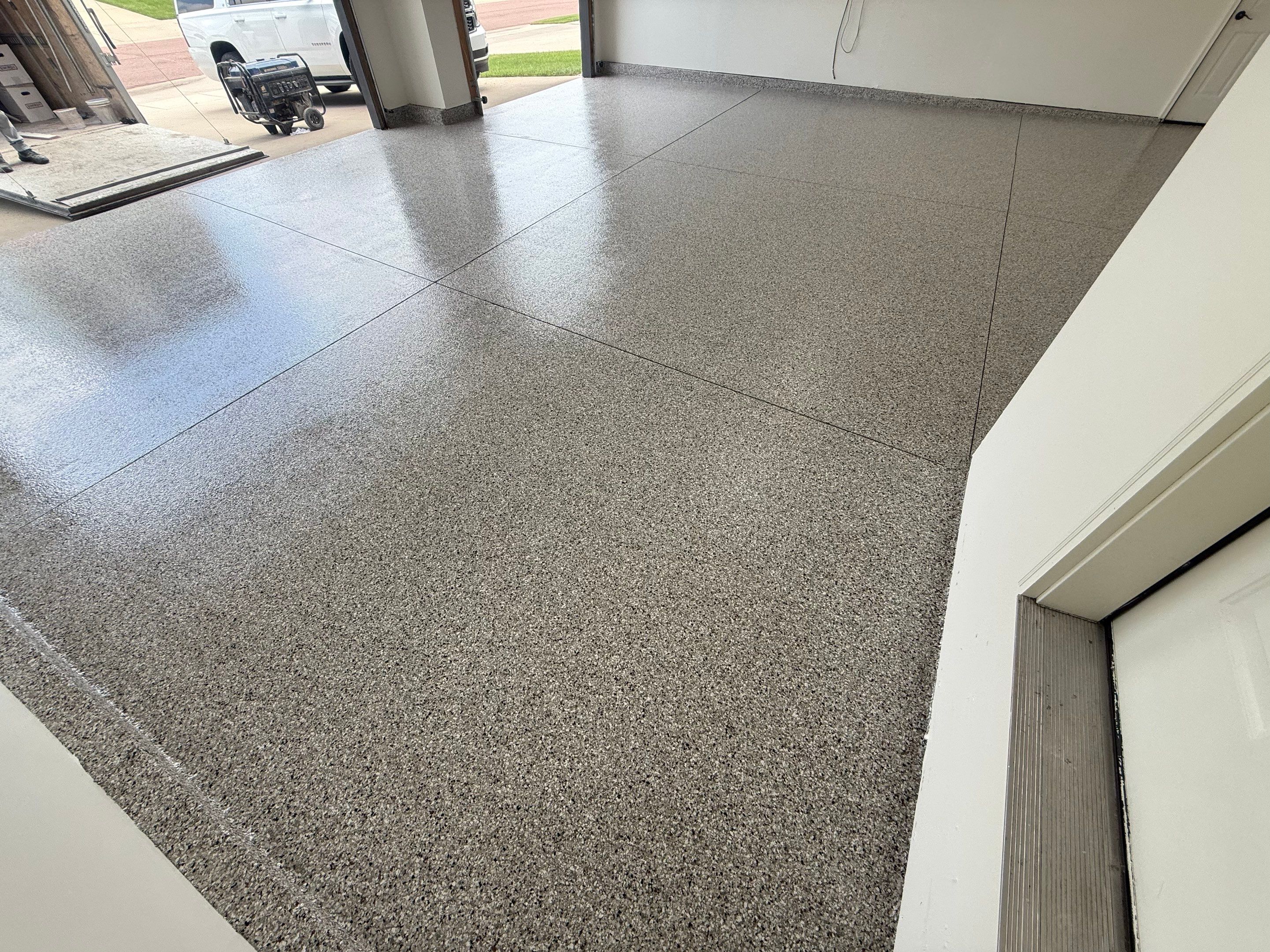 Full Garage Floor Resurfacing and Decorative Epoxy Flake Finish by Select Painting, Coatings & Garage Cabinets