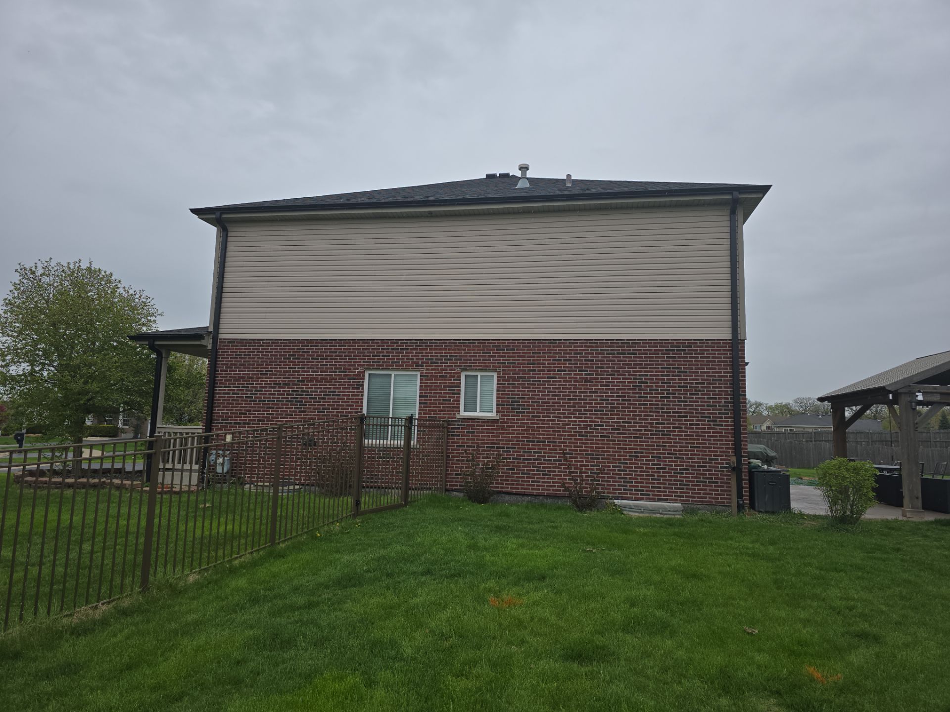 New black gutters and roof by Optimal Home Improvement 