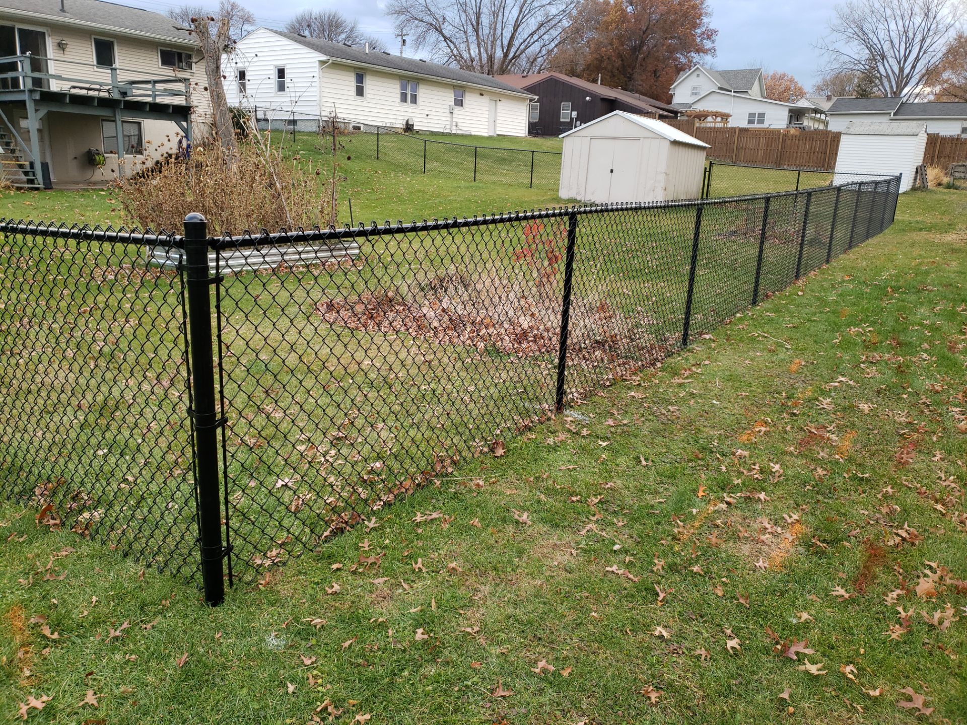 Residential Black Vinyl-Coated Chain Link Fence in Grundy Center by Perfect Picket Fence and Stain