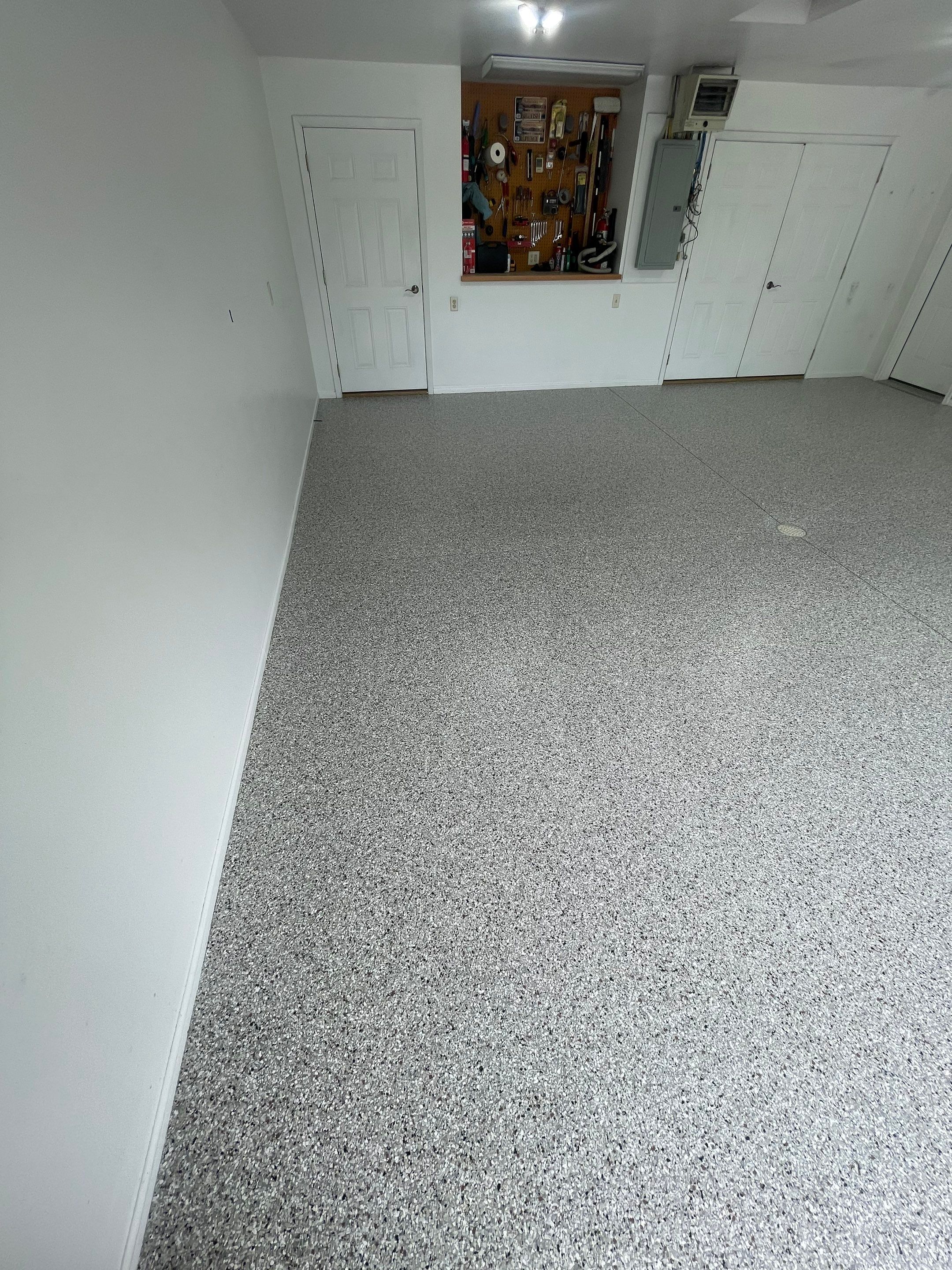 Coyote Flake Garage Floor Coating in Worthington, Minnesota by Select Painting, Coatings & Garage Cabinets