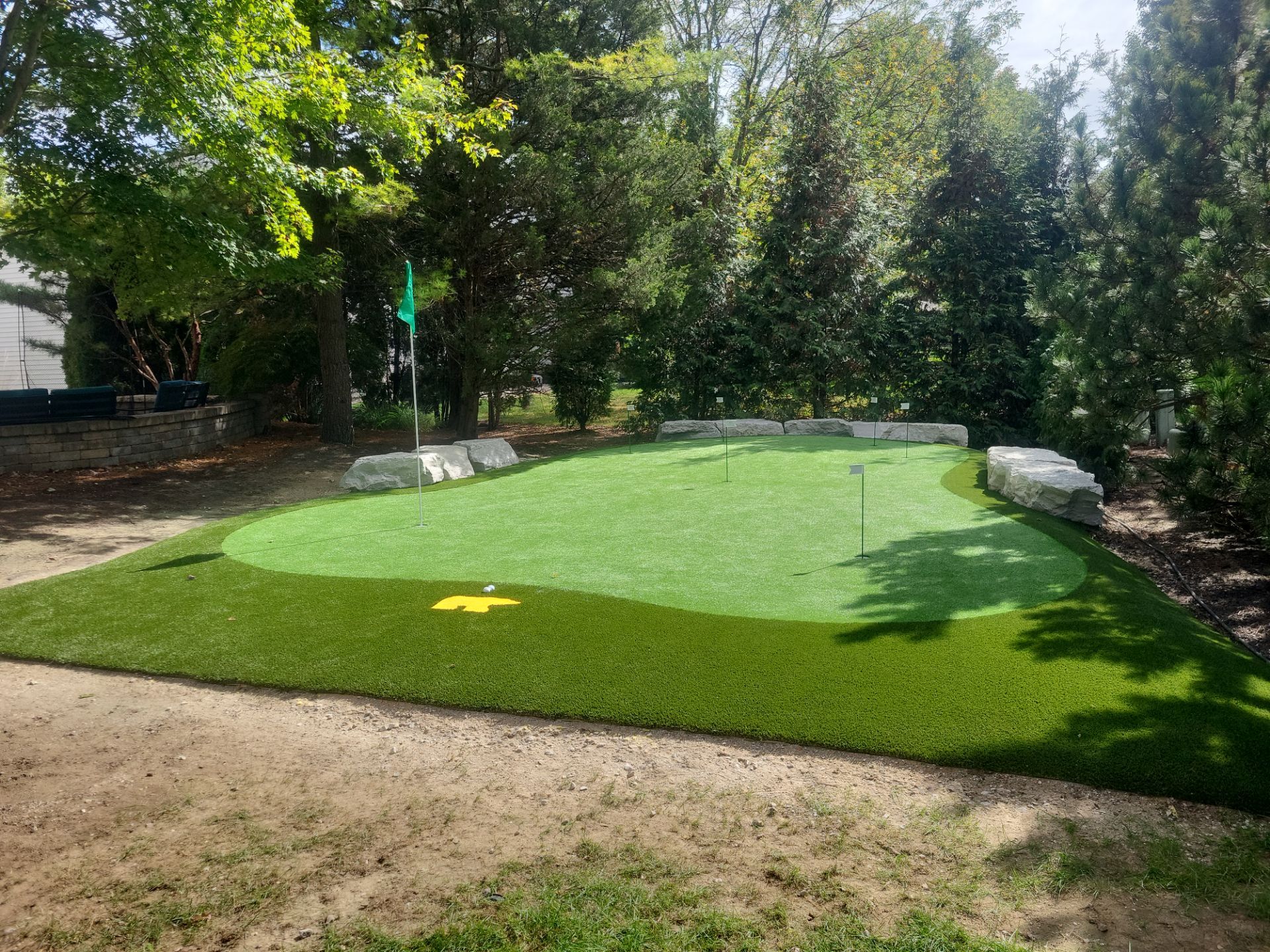 Custom Backyard Putting Green around Landscape Boulders in Hilliard by Southwest Greens Midwest