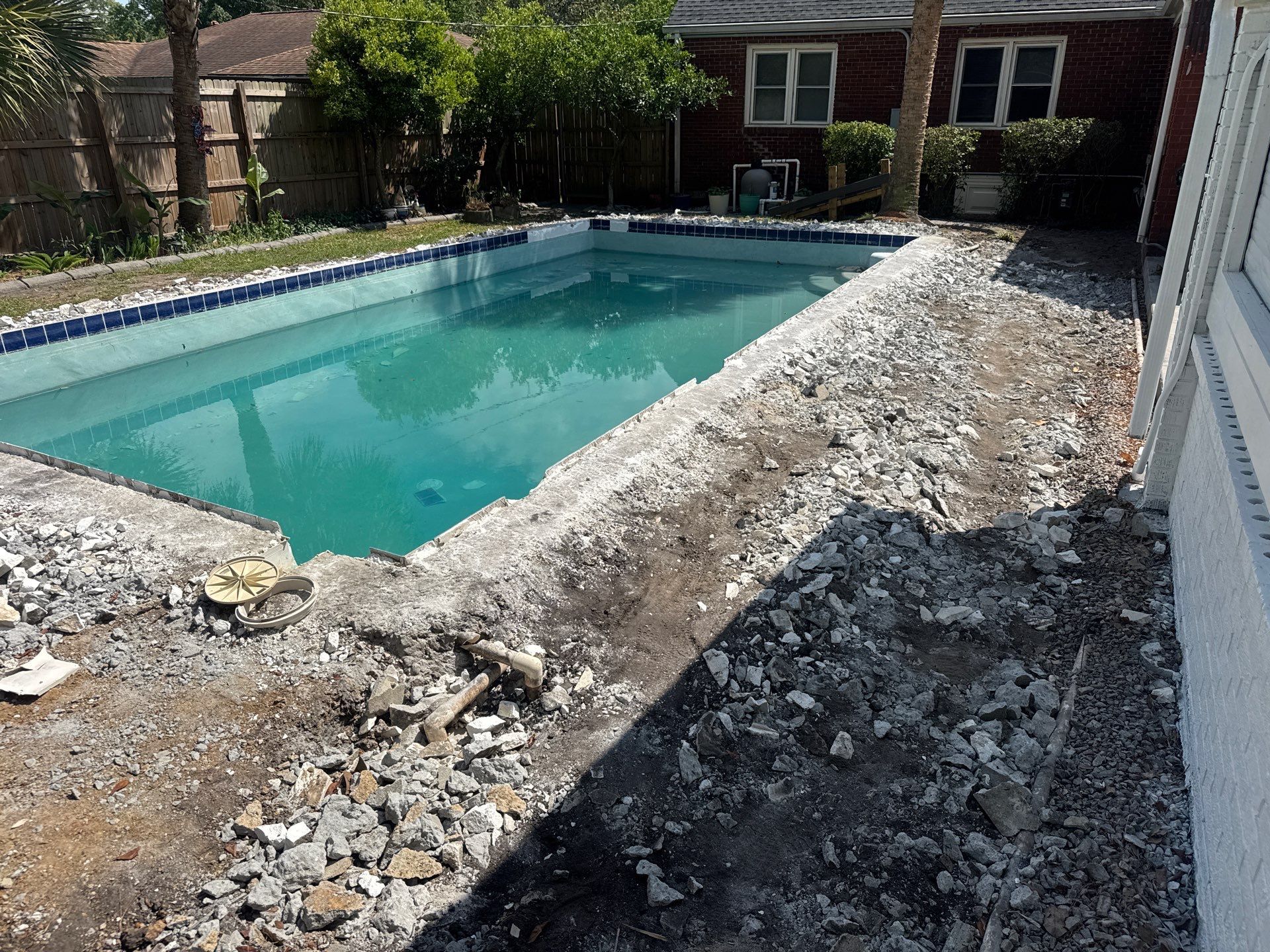 Savannah Pool Deck Replacement with Textured Concrete and Brick Coping by Lowcountry Scapes, LLC