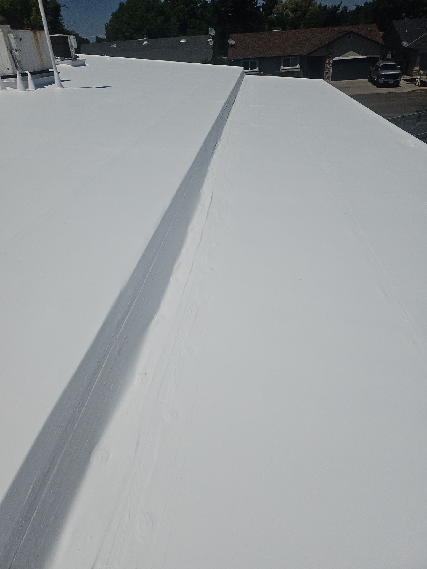 Single-ply restoration system using Benchmark/PUMA XL coatings over TPO single-ply roofing by Straight Edge Roofing Inc