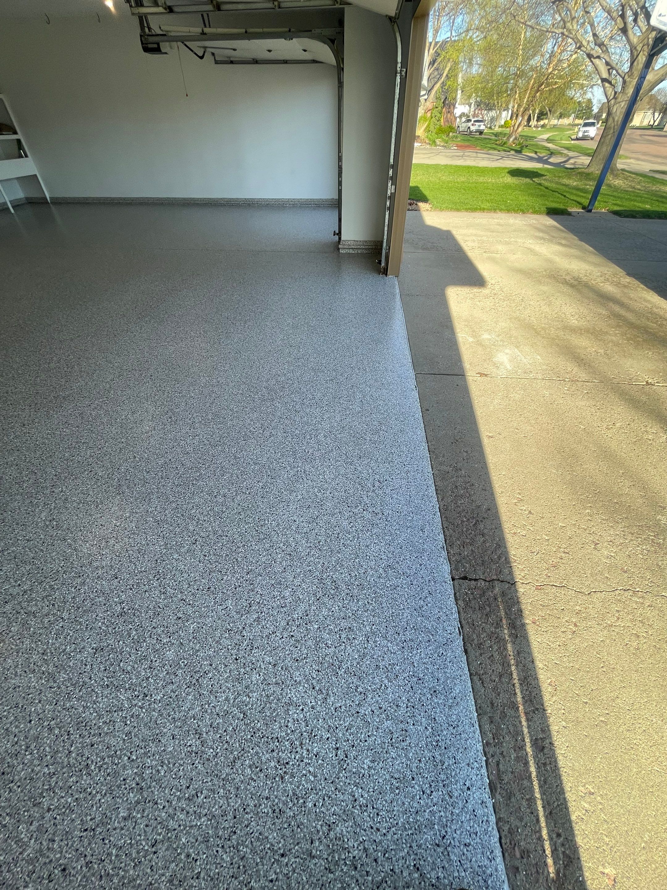 Yankton Garage Floor Restoration with Gray Speckled Epoxy Coating by Select Painting, Coatings & Garage Cabinets