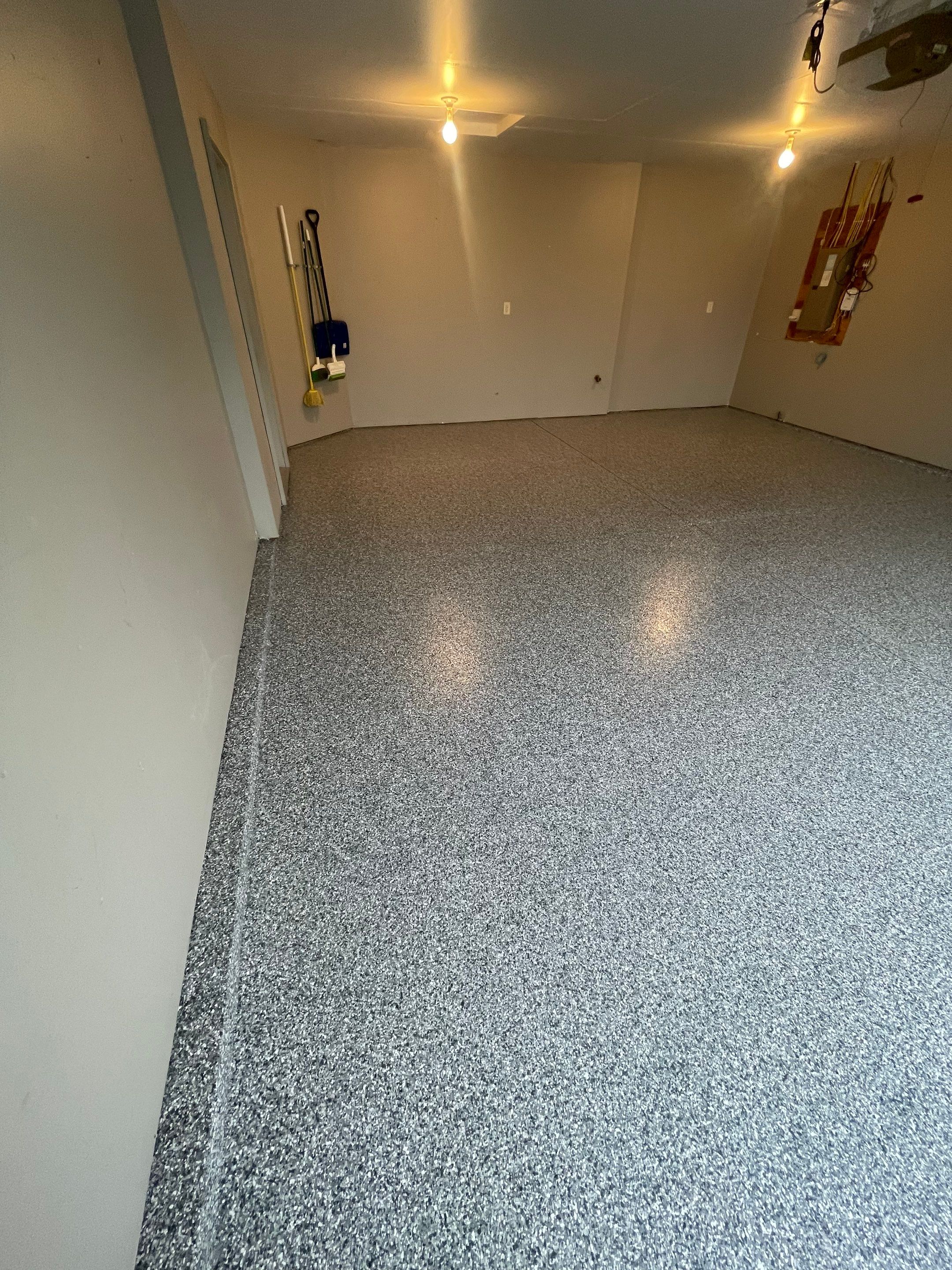 Custom Polyurea Flake Garage Floor Installation in Sioux Falls by Select Painting, Coatings & Garage Cabinets