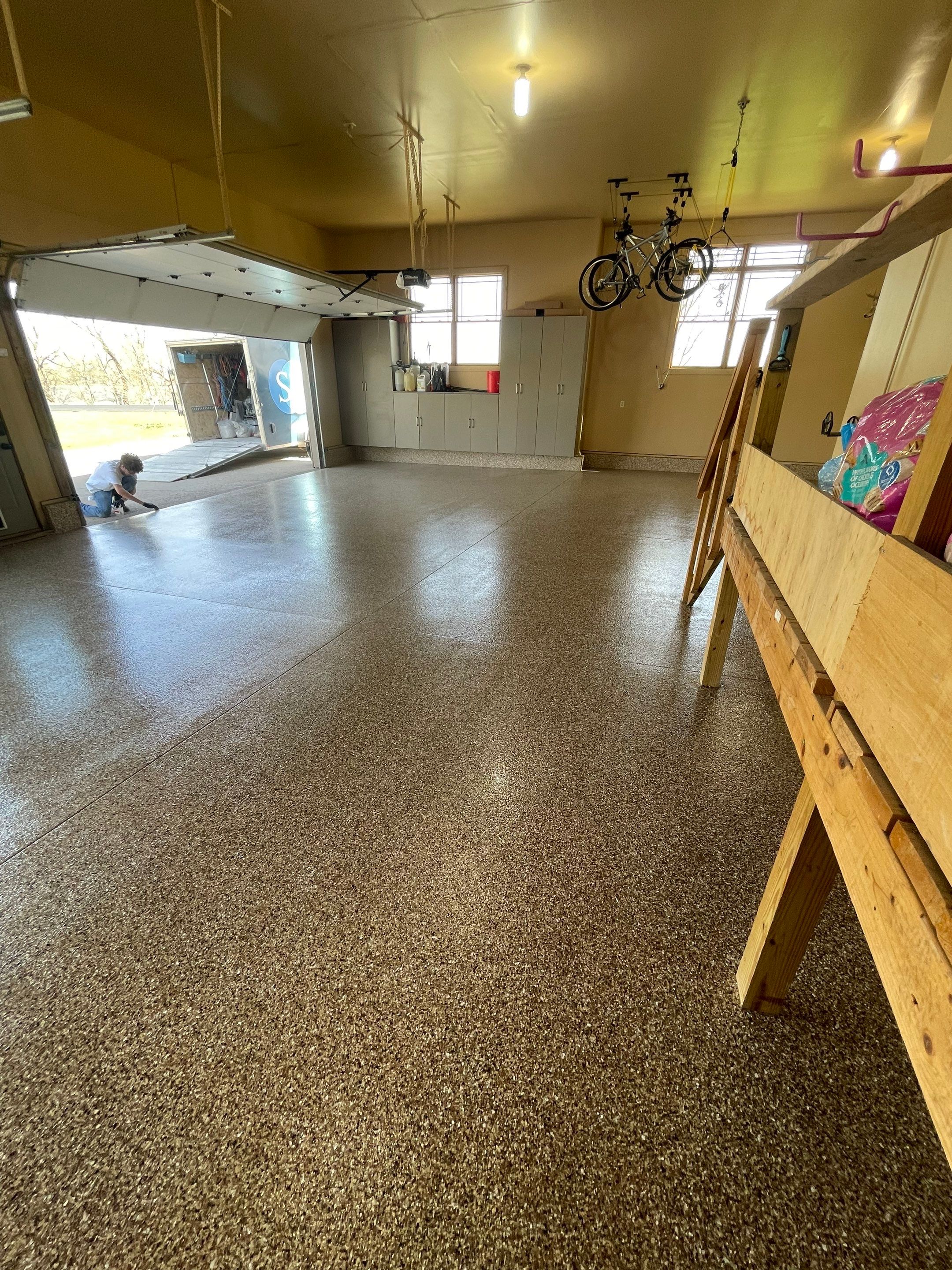 Residential Garage Floor Transformation with Speckled Epoxy Coating by Select Painting, Coatings & Garage Cabinets